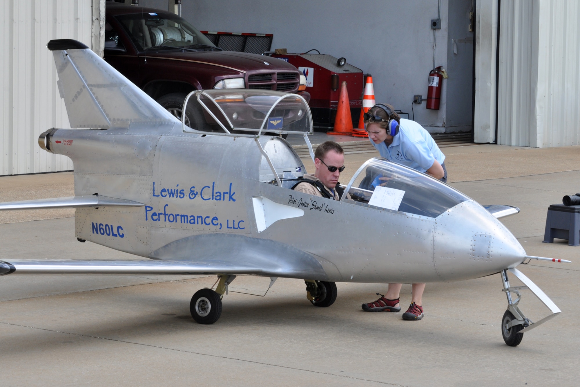 Justin “Shmed” Lewis, chief FLS Microjet pilot and team owner, prepares for takeoff with the assistance of his wife Sarah at the “Wings Over Tyler Air Show” at the Tyler Pounds Regional Airport in Tyler, Texas, July 3, 2011. Since its conception in the 1970s, “The World’s Smallest Jet” has been thrilling air show audiences all over the world. The FLS Microjet is a high performance, aerobatic, single seat, low-wing, all metal, Jet powered aircraft built from an amateur homebuilder kit. (U.S. Air Force photo/Tech. Sgt. Jeff Walston)