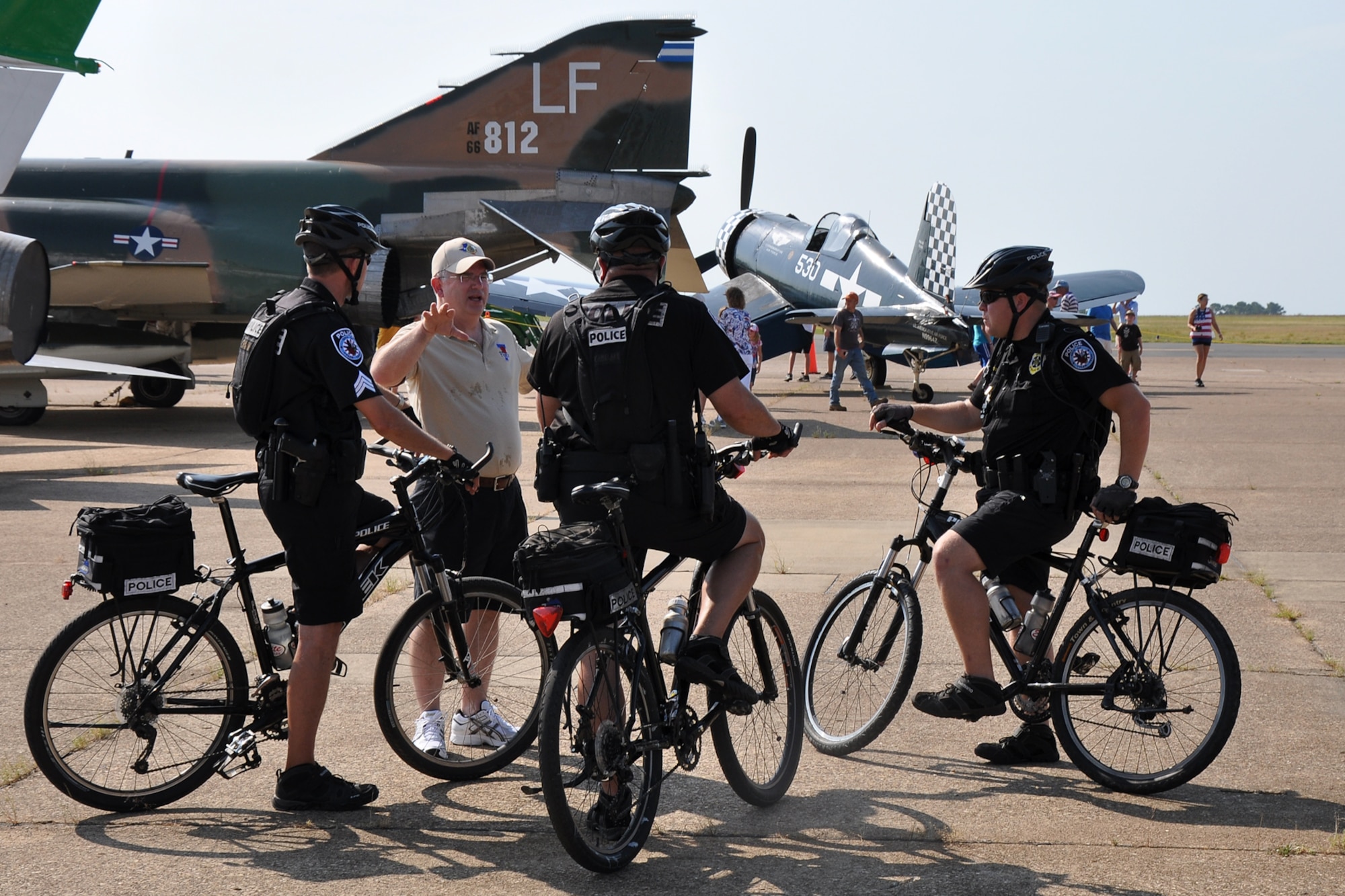 Police Chief Gary M. Swindle, of the City of Tyler, Texas, speaks with several of his uniformed officers before the opening ceremony of the “Wings Over Tyler Air Show” at the Tyler Pounds Regional Airport, July 3, 2011. A number of Tyler and Smith County law enforcement officers stood watch over air show spectators, the perimeter and aircraft at the air show. (U.S. Air Force photo/Tech. Sgt. Jeff Walston)