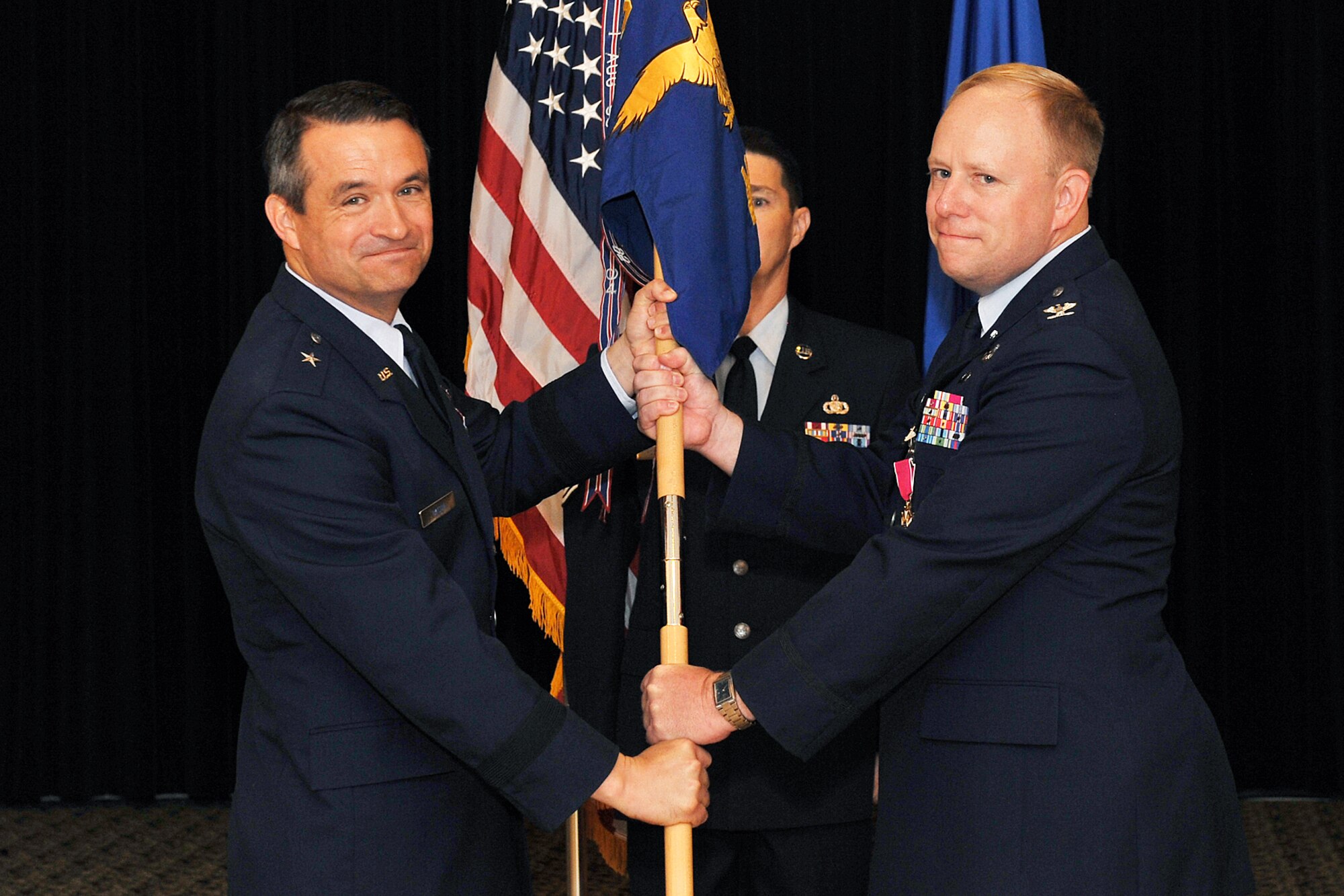 U.S. Air Force Col. Michael Allshouse, former 55th Mission Support Group commander, passes the guidon to Brig. Gen. Donald Bacon, 55th Wing commander, during a change of command ceremony inside the Patriot Club on Offutt Air Force Base, Neb., July 6. 

U.S. Air Force Photo by Charles Haymond