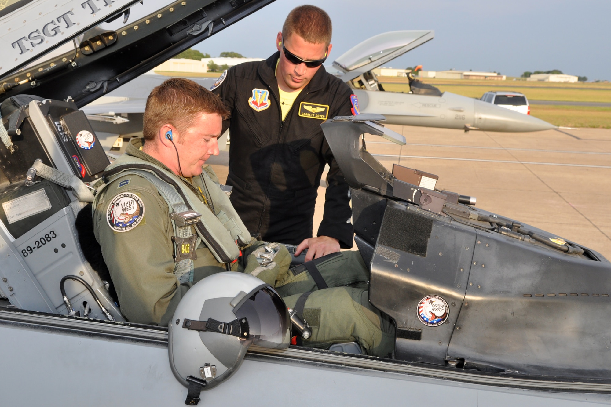 Staff Sgt. Graham Fitzpatrick, crew chief, helps strap in Capt. Garrett Dover, pilot, into an F-16 Fighting Falcon before launching the jet to participate in the Cedar Creek Lake Air Show, “Thunder Over Cedar Creek Lake,” near Mabank, Texas, July 2, 2011. The jet was launched from Tyler Pounds Regional Airport in Tyler, Texas. Both Airmen are assigned to the Viper West F-16 Demonstration Team, 388th Fighter Wing, Hill Air Force Base, Utah. (U.S. Air Force photo/Tech. Sgt. Jeff Walston) 