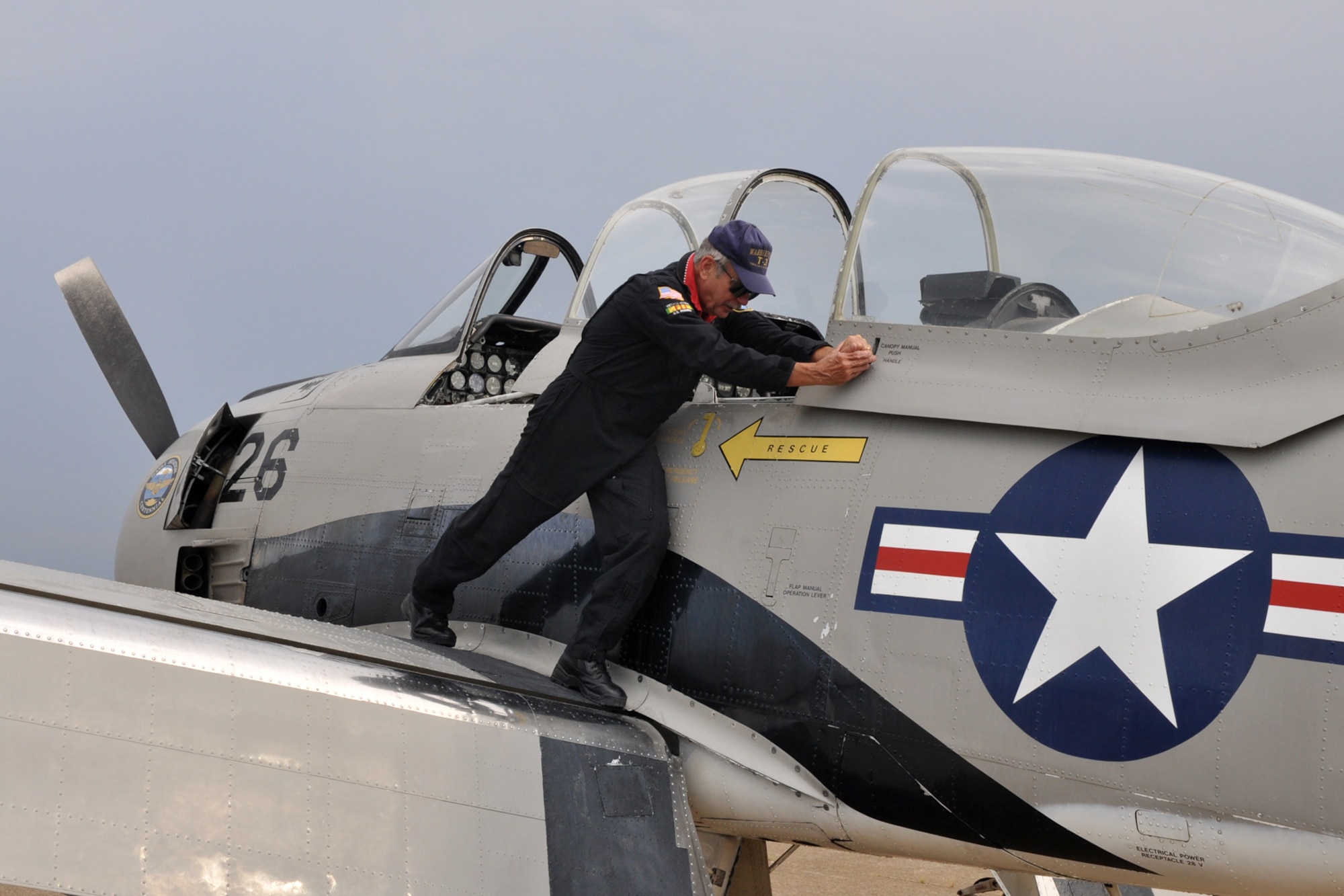 Col. (Ret) John “Slick” Sledge, U.S. Marine Corps, opens the canopy during a pre-flight check before taking off to participate in the Cedar Creek Lake Air Show, “Thunder Over Cedar Creek Lake,” near Mabank, Texas, July 2, 2011. Colonel Sledge launched the North American T-28 Trojan from the Tyler Pounds Regional Airport in Tyler, Texas. He flies with the Trojan Phlyers T-28 Flight Demonstration Team from Fort Worth, Texas. Colonel Sledge was also one of the featured performers at the “Wings Over Tyler Air Show” at the Tyler Pounds Regional Airport, July 3, 2011. (U.S. Air Force photo/Tech. Sgt. Jeff Walston) 