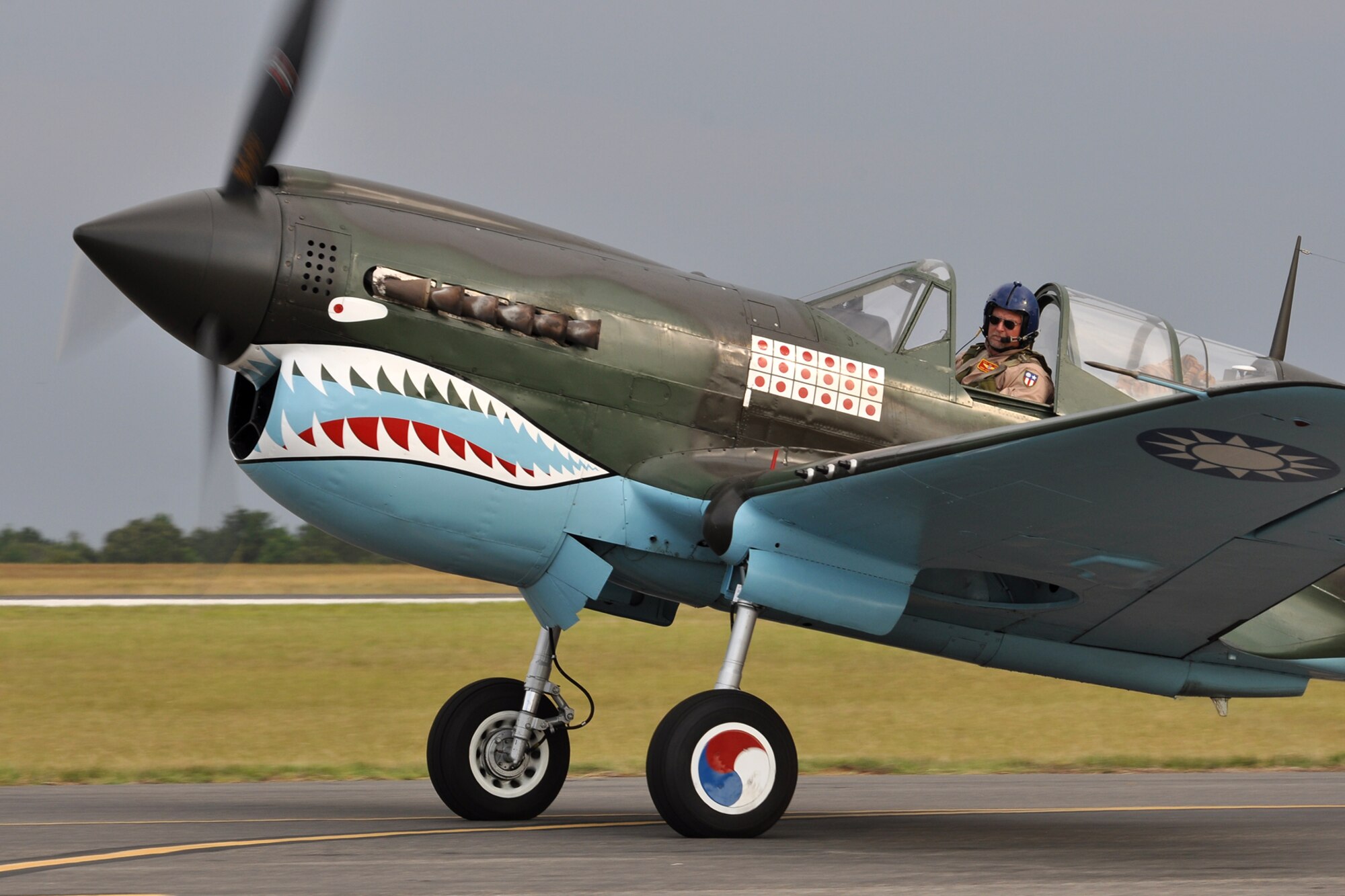 Mike Anderson taxis his Curtis P-40 Warhawk to the runway before take-off at Tyler Pounds Regional Airport in Tyler, Texas, July 2, 2011. Anderson was preparing to participate in the Cedar Creek Lake Air Show, “Thunder Over Cedar Creek Lake,” near Mabank, Texas. The aircraft is owned by the Commemorative Air Force, and Anderson has more than 4,000 total hours flying. He also flies the P-40 in the “Tora! Tora! Tora!” re-enactment, a spectator favorite at air shows across the country. (U.S. Air Force photo/Tech. Sgt. Jeff Walston)
