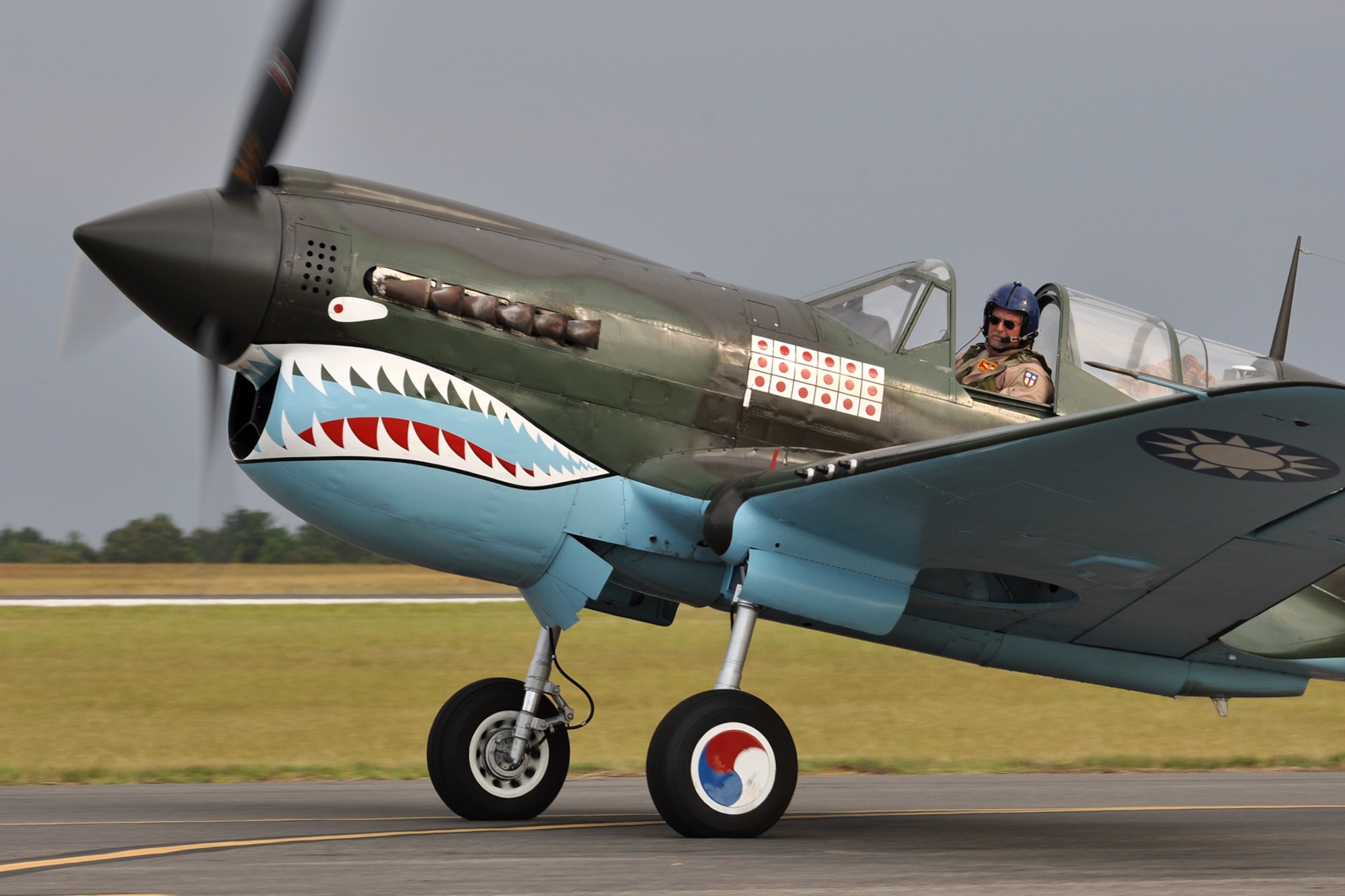 Mike Anderson taxis his Curtis P-40 Warhawk to the runway before take-off at Tyler Pounds Regional Airport in Tyler, Texas, July 2, 2011. Anderson was preparing to participate in the Cedar Creek Lake Air Show, “Thunder Over Cedar Creek Lake,” near Mabank, Texas. The aircraft is owned by the Commemorative Air Force, and Anderson has more than 4,000 total hours flying. He also flies the P-40 in the “Tora! Tora! Tora!” re-enactment, a spectator favorite at air shows across the country. (U.S. Air Force photo/Tech. Sgt. Jeff Walston)