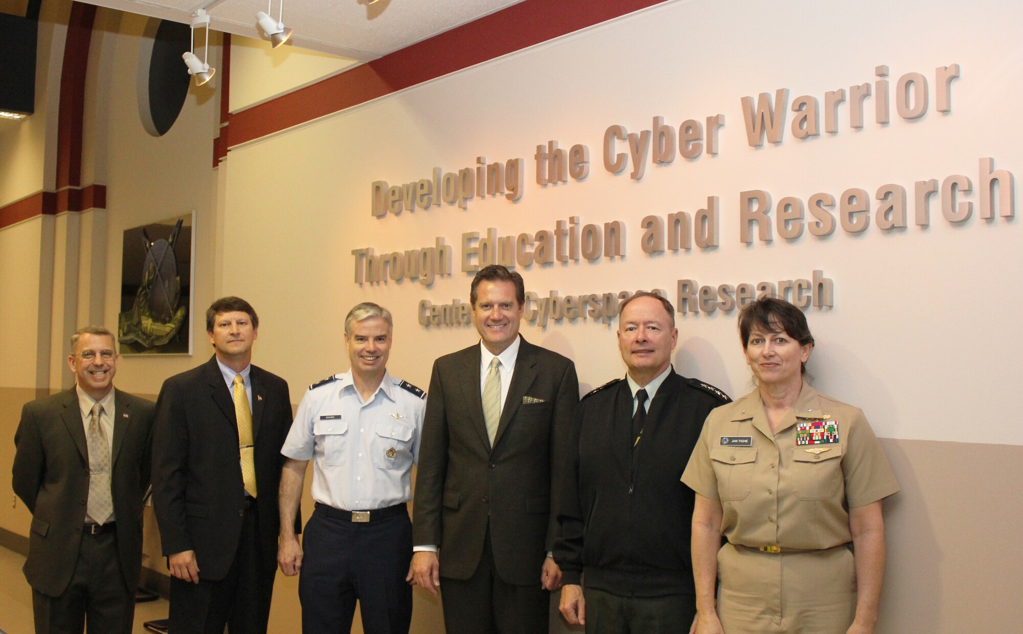 Army Gen. Keith B. Alexander, Commander of U.S. Cyber Command, Director of the National Security Agency and Chief of the Central Security Service visits the Air Force Institute of Technology's Cyberspace Research Center along with Ohio Congressman Michael Turner on June 20, 2011.  CCR is the only Air Force Cyberspace Technical Center of Excellence that is chartered to be a unifying and synergistic body for promoting cyberspace education, training, research, and technology development. This designation enhances CCR’s ability to be a clearinghouse for “who does what” and “who needs what” in cyber.  (Left to right in photo)  Dr. Harold Arata, CCR Associate Director, Dr. Richard Raines, CCR Director, Maj. Gen. Walter Givhan, AFIT Commandant, Congressman Turner, General Alexander and Rear Adm. Jan Tighe Deputy Director of Operations for U.S. Cyber Command. 