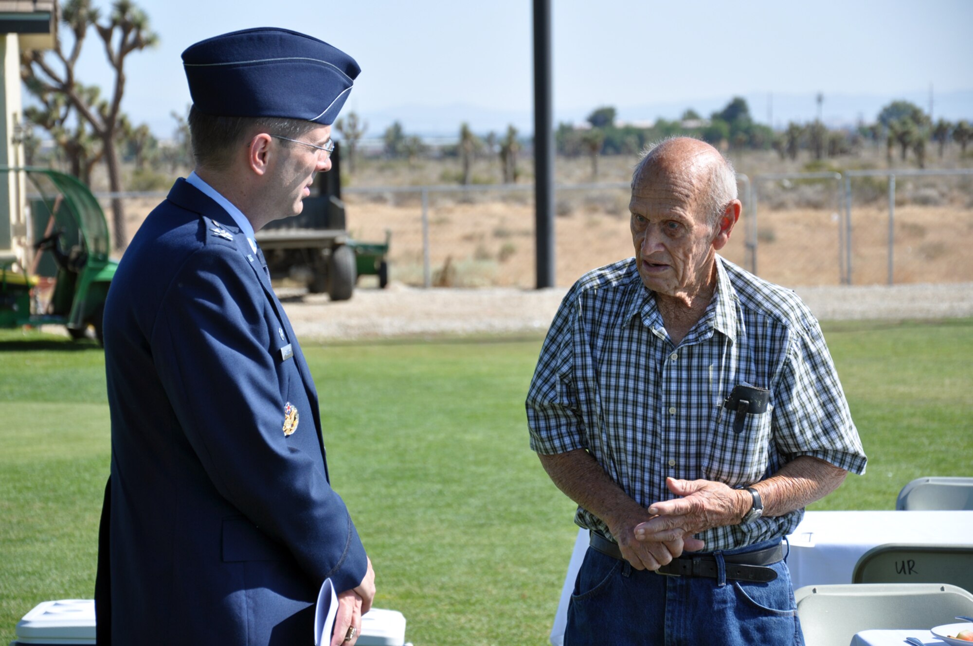 Col. Gregory E. Schwab, 95th Air Base Wing commander, visits with an Antelope Valley veteran during the July 3 event. Colonel Schwab recognized Veterans for Trees for keeping veterans' stories alive in the minds of all Americans. (Air Force photo by Mike Strickler)