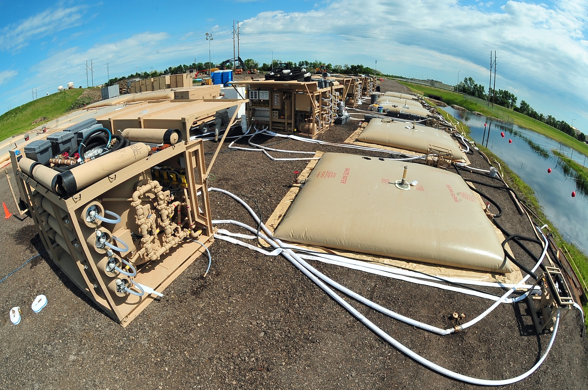 MINOT AIR FORCE BASE, N.D. -- Six reverse osmosis water purification units are fully functional and running to ensure the continuation of water supply throughout Minot Air Force Base. An additional two units have been designated as reserve components and are on standby mode. These water purification units were shipped recently from Holloman AFB, N.M and can produce nearly a quarter million gallons of purified water per day. (U.S. Air Force photo/Senior Airman Jesse Lopez)