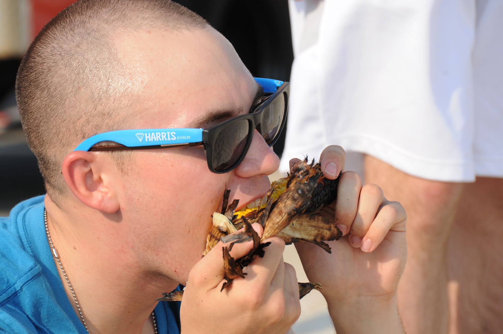 Airman 1st Class Daniel Johnson, 338th Training Squadron student, eats grilled corn on the cob during Keesler's 4th of July Beach Bash  (U.S. Air Force photo by Kemberly Groue)