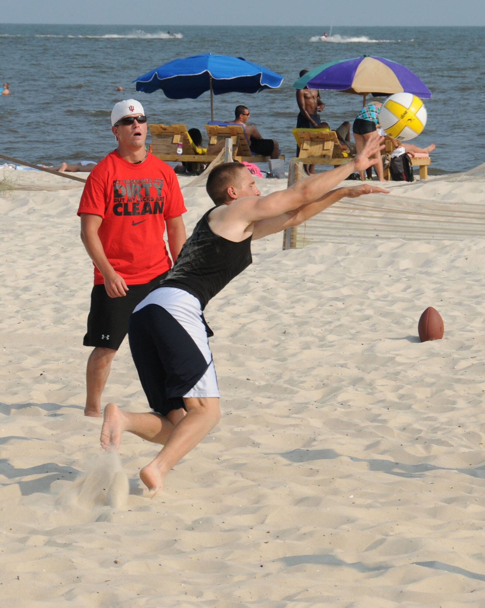 Airman Basic Patrick Risch, 334th Training Squadron student and Airman Basic Jay Werley, 338th Training Squadron student play volley ball at Keesler's 4th of July Beach Bash.  (U.S. Air Force photo by Kemberly Groue)