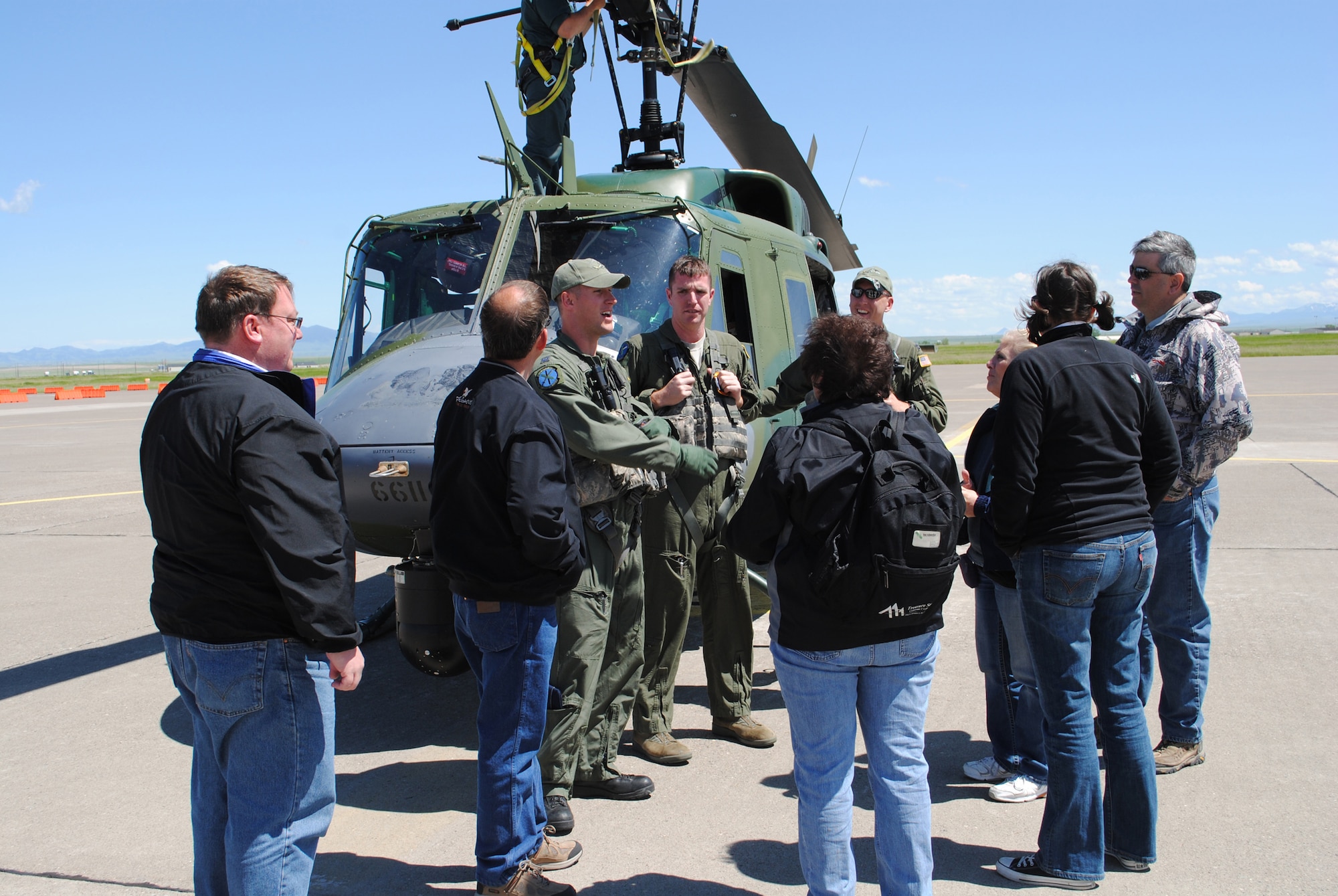 Members of the Military Affairs Committee listen to their crew talk about the UH-1N Huey and its capabilities.  The MAC members were split into three groups and flown to a missile alert facility.  (U.S. Air Force photo/Airman Cortney Hansen)