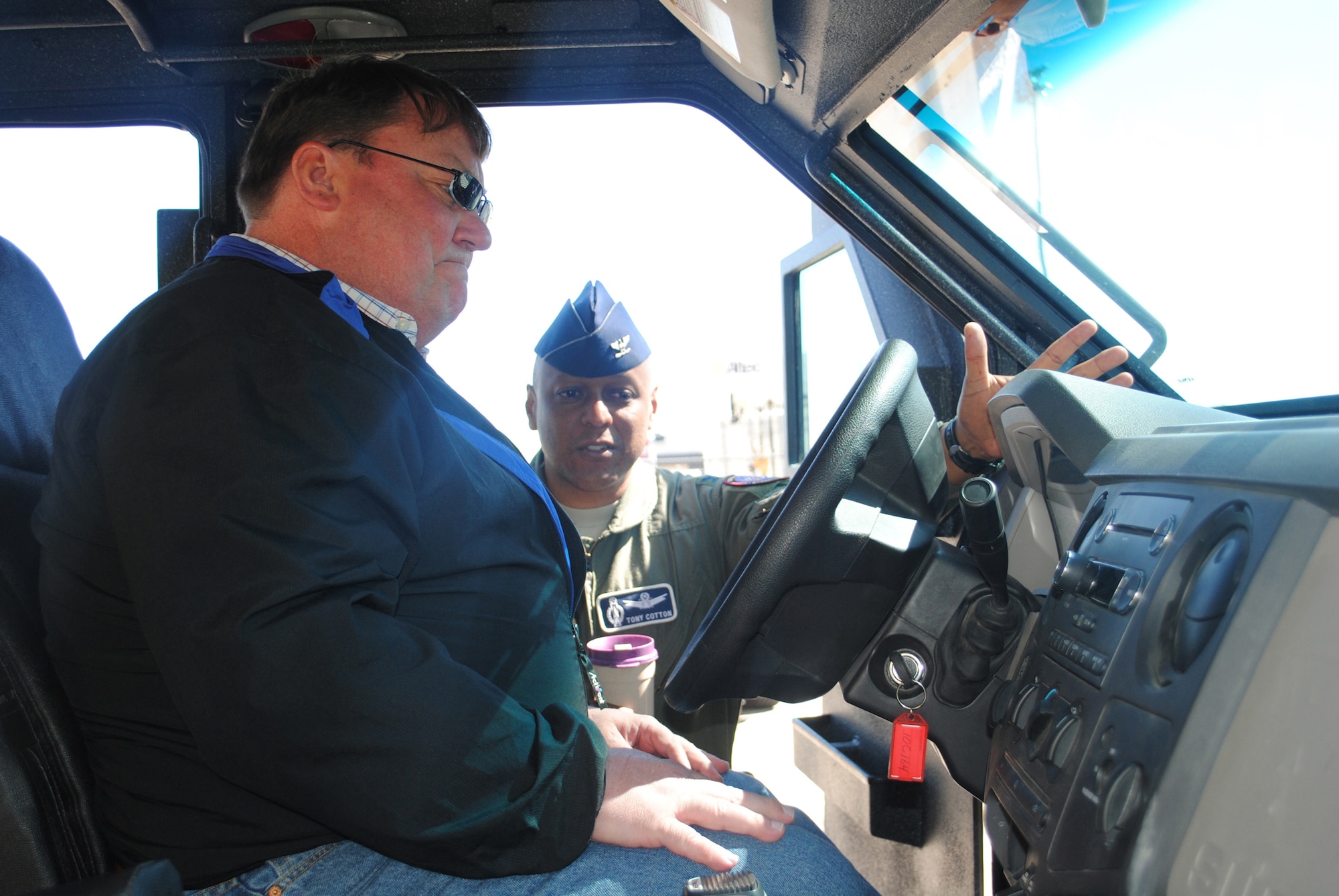 Brig. Gen. (Sel) Anthony Cotton, 341st Missile Wing commander, explains to Steve Grooms, Military Affairs Committee chairman, the similarities a Bearcat interior has to a regular Ford F-Series.  Various vehicles that would be involved in a convoy were on display for the MAC members to learn about.  (U.S. Air Force photo/Airman Cortney Hansen)