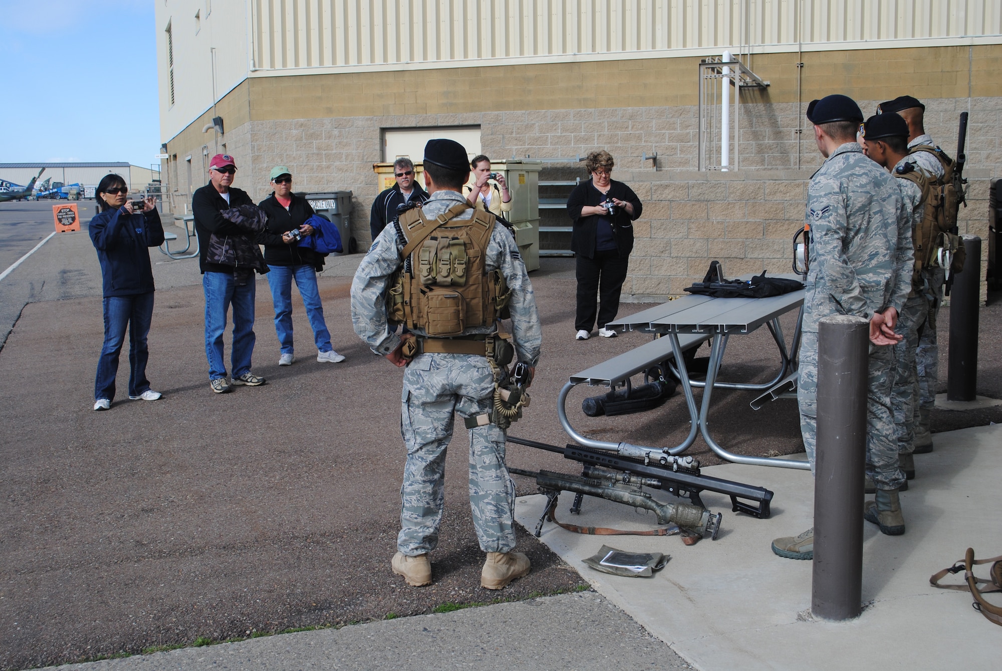 Members of the Military Affairs Committee listen to members of the Tactical Response Force talk about the various weapons they are trained to use.  MAC members were also exposed to members of the Convoy Response Force and crews of the UH-1N Hueys June 25.  (U.S. Air Force photo/Airman Cortney Hansen)