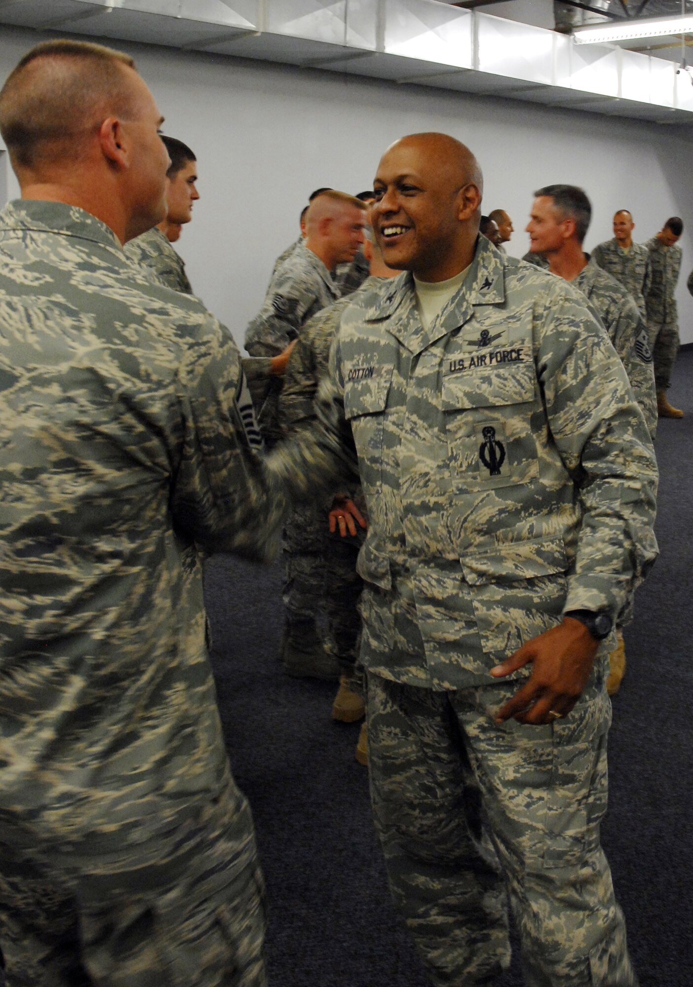 Brig. Gen. (Sel) Anthony Cotton shakes hands with Master Sgt. Shane Matt, 341st Civil Engineer Squadron first sergeant, duing in-processing at building 3080 June 23. The 341st Missile Wing Commander and Command Chief Master Sergeant were welcoming the more than 20 engineers back to Malmstrom following their deployment. (U.S. Air Force photo/Jessica Galloway)