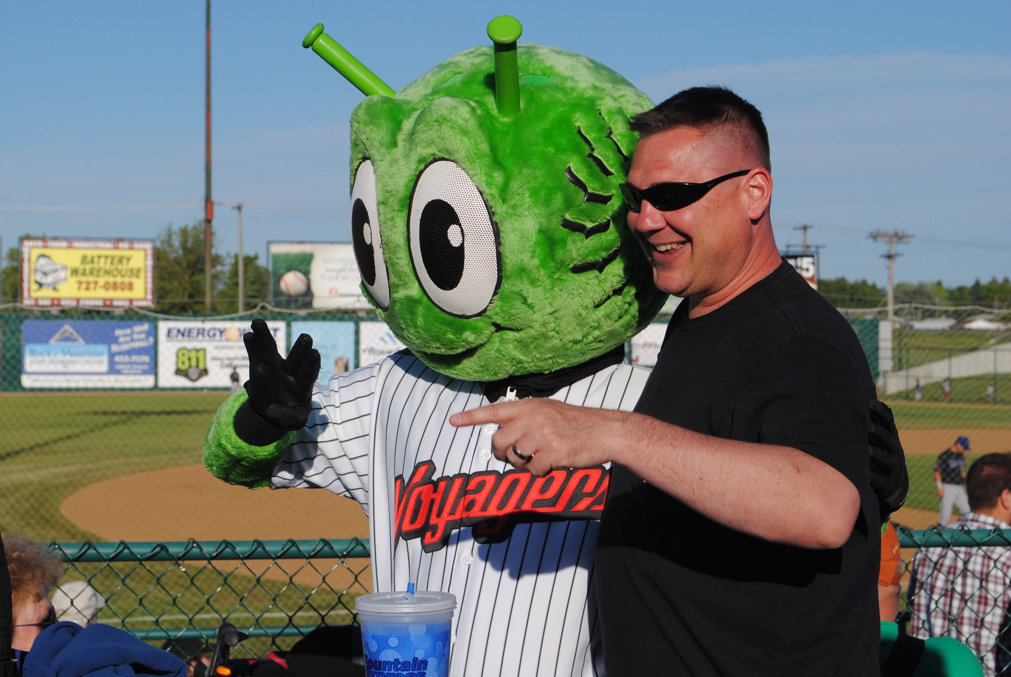 Tech. Sgt. Sean Walsh, 12th Missile Squadron missile chef, poses with Orbit, the Great Falls Voyagers' mascot. (U.S. Air Force photo/Airman Cortney Hansen)