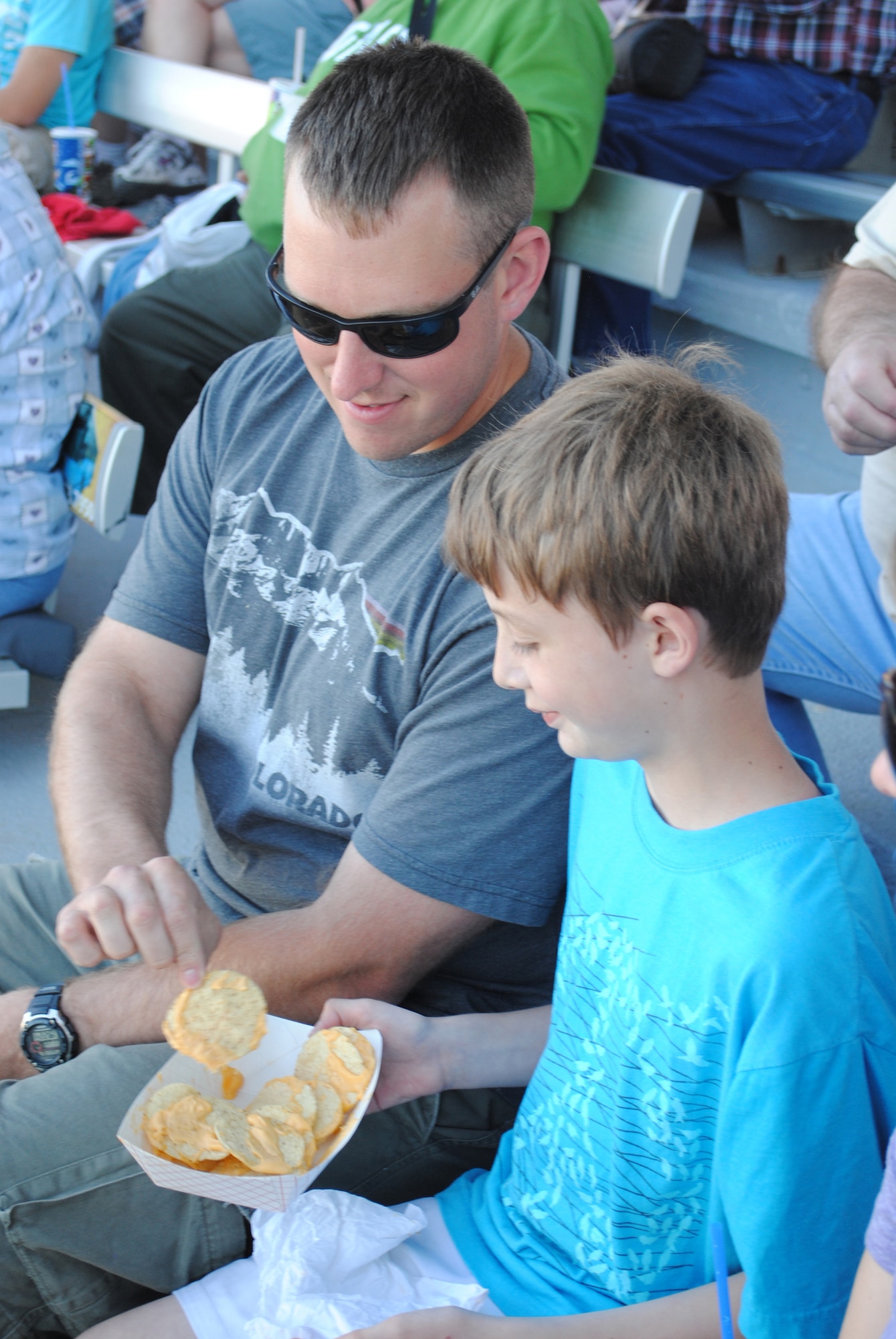 1st Lt. Daniel Hejde, 341st Operations Support Squadron deputy missile combat crew commander instructor, shares nachos with his little brother, Noah, 10, with whom he was matched through the Big Brothers Big Sisters program.  They enjoyed the Great Falls Voyagers game, which was free to military members on Military Appreciation Day.  (U.S. Air Force photo/Airman Cortney Hansen)  