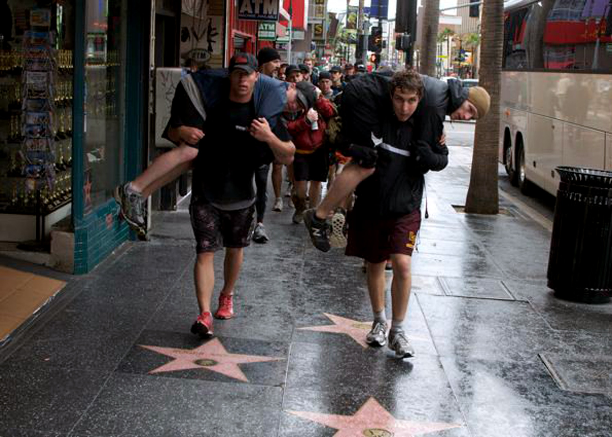 Participants in the GORUCK Challenge in Los Angeles buddy-carry each other down Hollywood's “Walk of Fame” as a feat in the challenge. Edwards Airmen 1st Lt. Paul Issler from the 412th Test Management Division and 1st Lt. Erin Wallace, 773rd Test Squadron, competed in the rucksack march through the city. The challenge involved performing calisthenics and carrying weight on their back for more than 12 hours. (Courtesy photo)