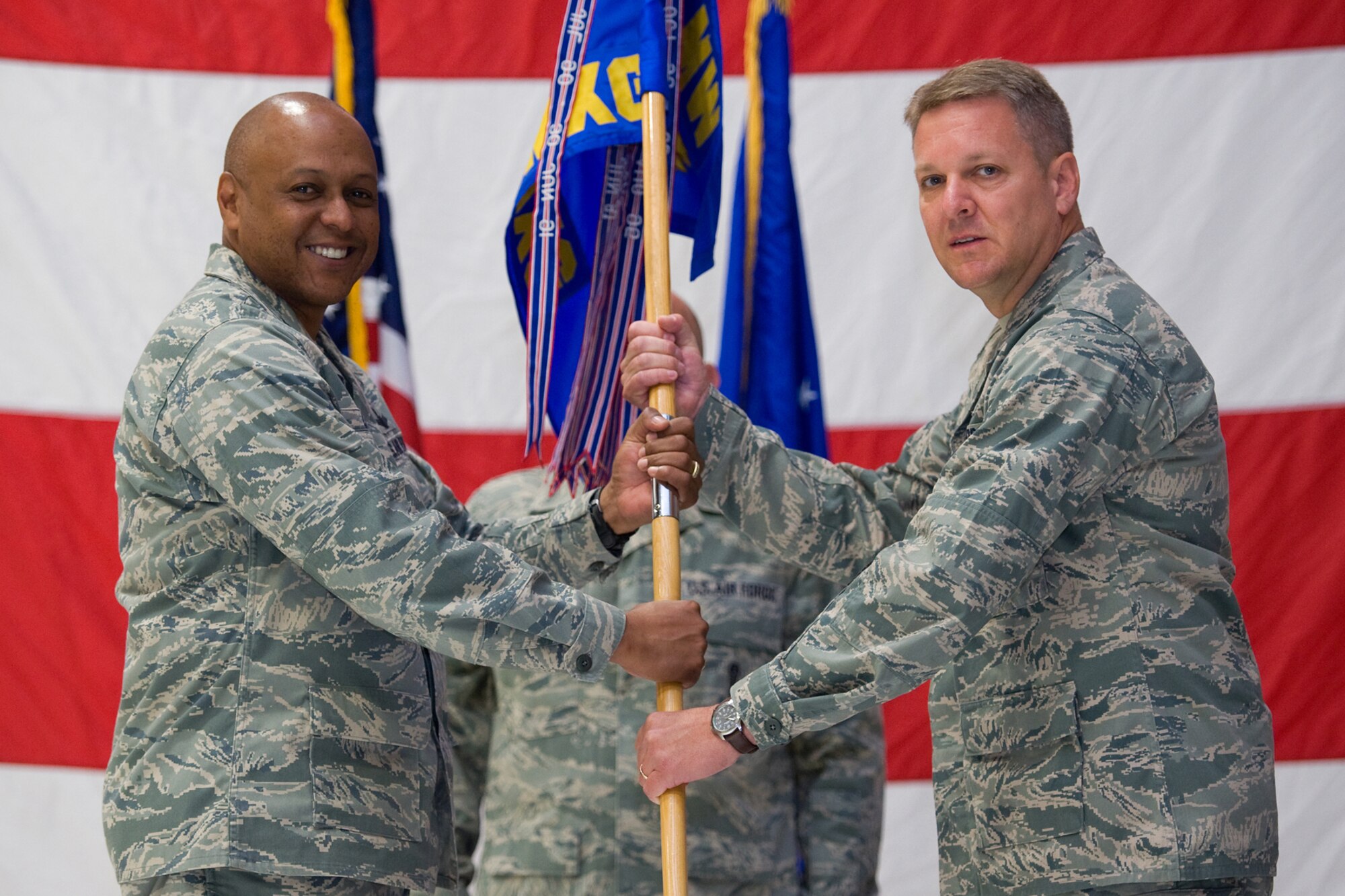 Col. David Bliesner accepts command of the 341st Maintenance Group from Brig. Gen. (Sel) Anthony Cotton, 341st Missile Wing commander, June 29, at the 3-Bay Hangar.  (U.S. Air Force photo/Beau Wade)