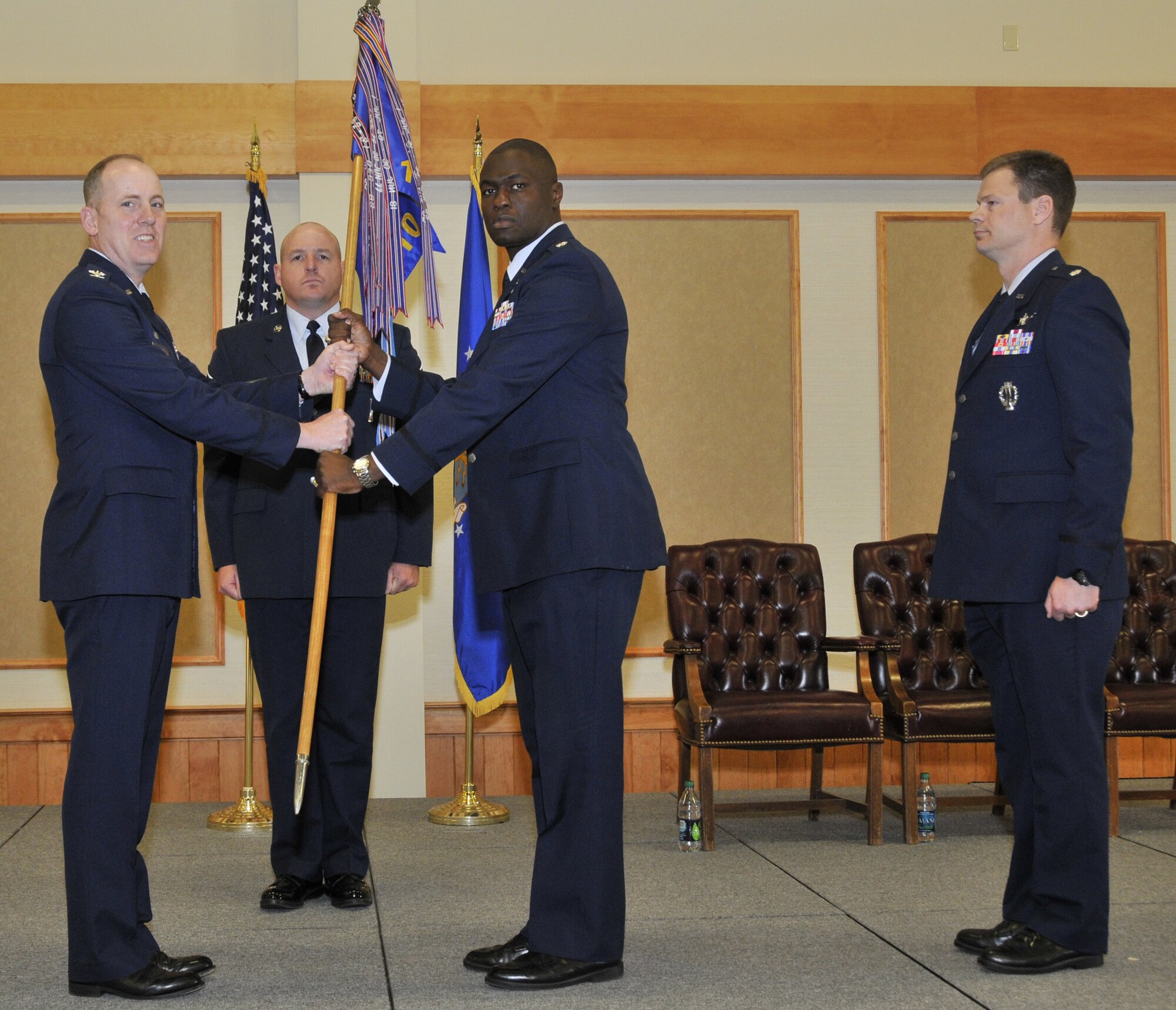 Lt. Col. Demetrius Walkters accepts command of the 10th Missile Squadron from Col. Edward Rimback, 341st Operations Group commander (left) June 24 as the group first sergeant Master Sgt. Robert Baker looks on. Outgoing 10th MS Commander Lt. Col. Peter Bonetti is also pictured. (U.S. Air Force photo John Turner)