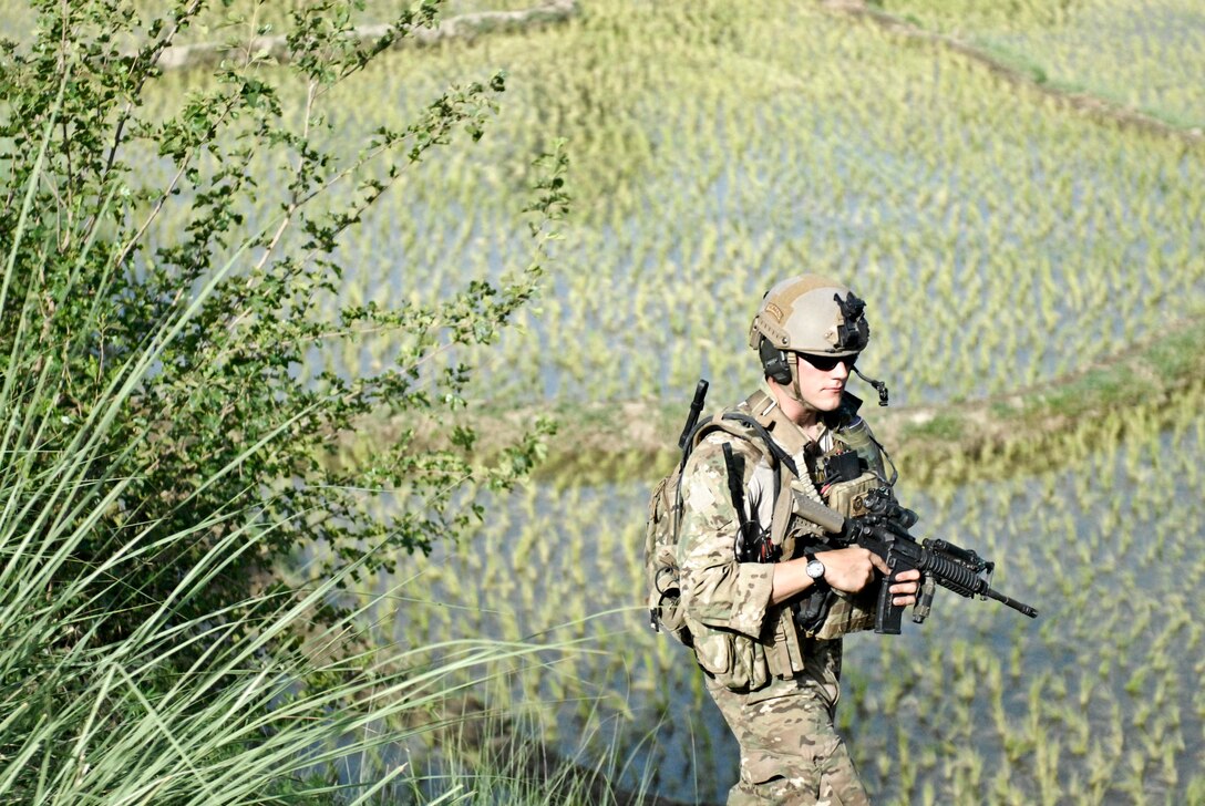 Senior Airman Michael McAffrey patrols alongside a field near Khanda Village in Laghman province, Afghanistan June 18, 2011. Airman McAffrey is a joint terminal attack controller with the Washington Air National Guard's 116th Air Support Operations Squadron. The efforts of Airman McAffrey and the other JTACs from the 116th ASOS were credited by Soldiers fighting in the battle of Do Ab May 25 as being the difference and saving many of the Soldiers' lives that day. (Courtesy Photo)