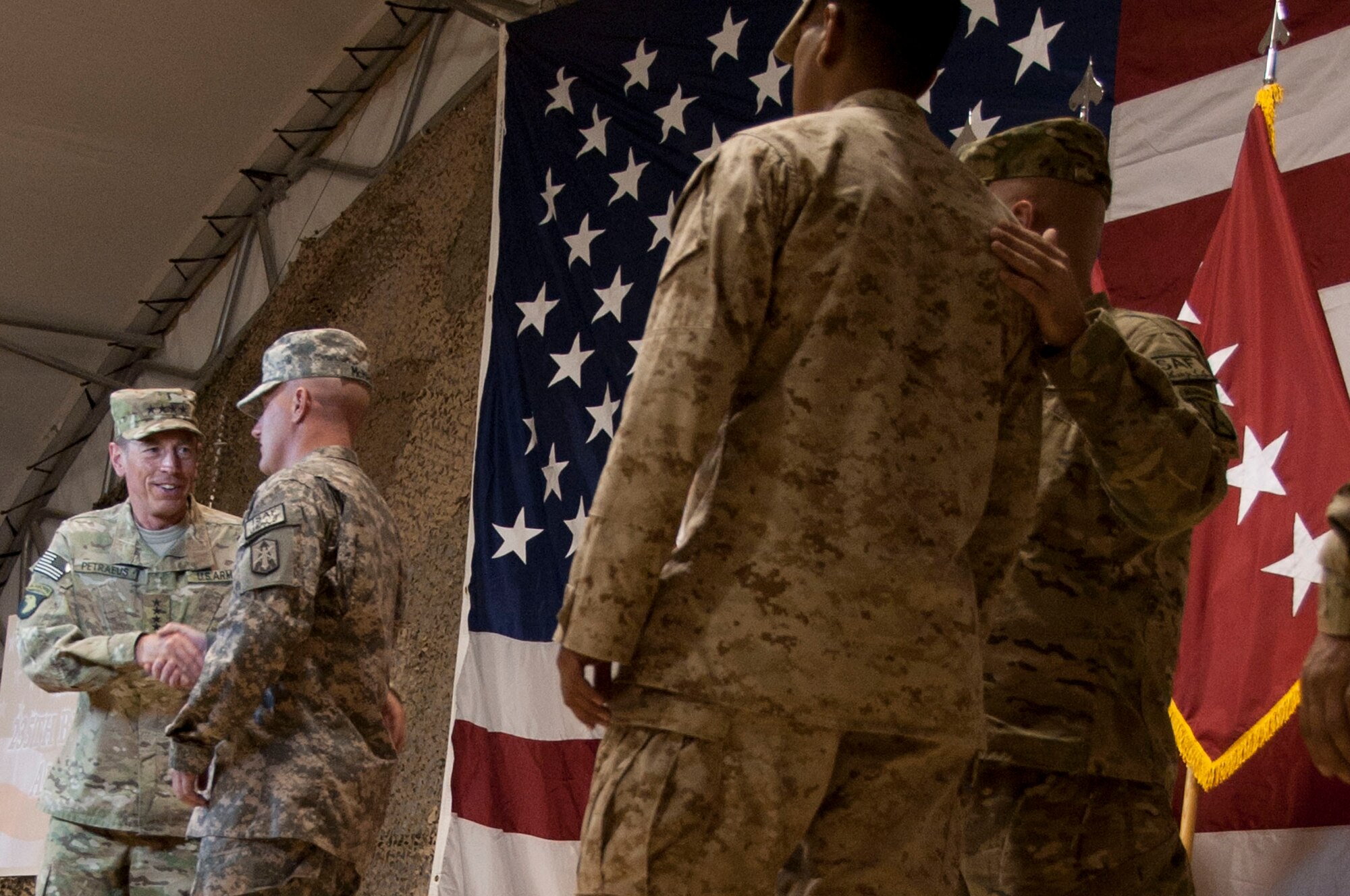 Army Gen. David H. Petraeus, senior commander of U.S. and coalition forces in Afghanistan, greets 235 service members after they re-enlisted under his reading at Kandahar Air Field, Afghanistan, July 4, 2011. This year, on July 4th, the United States celebrates the 235th anniversary of the signing of the Declaration of Independence. (U.S. Air Force photo by Senior Airman Corey Hook)