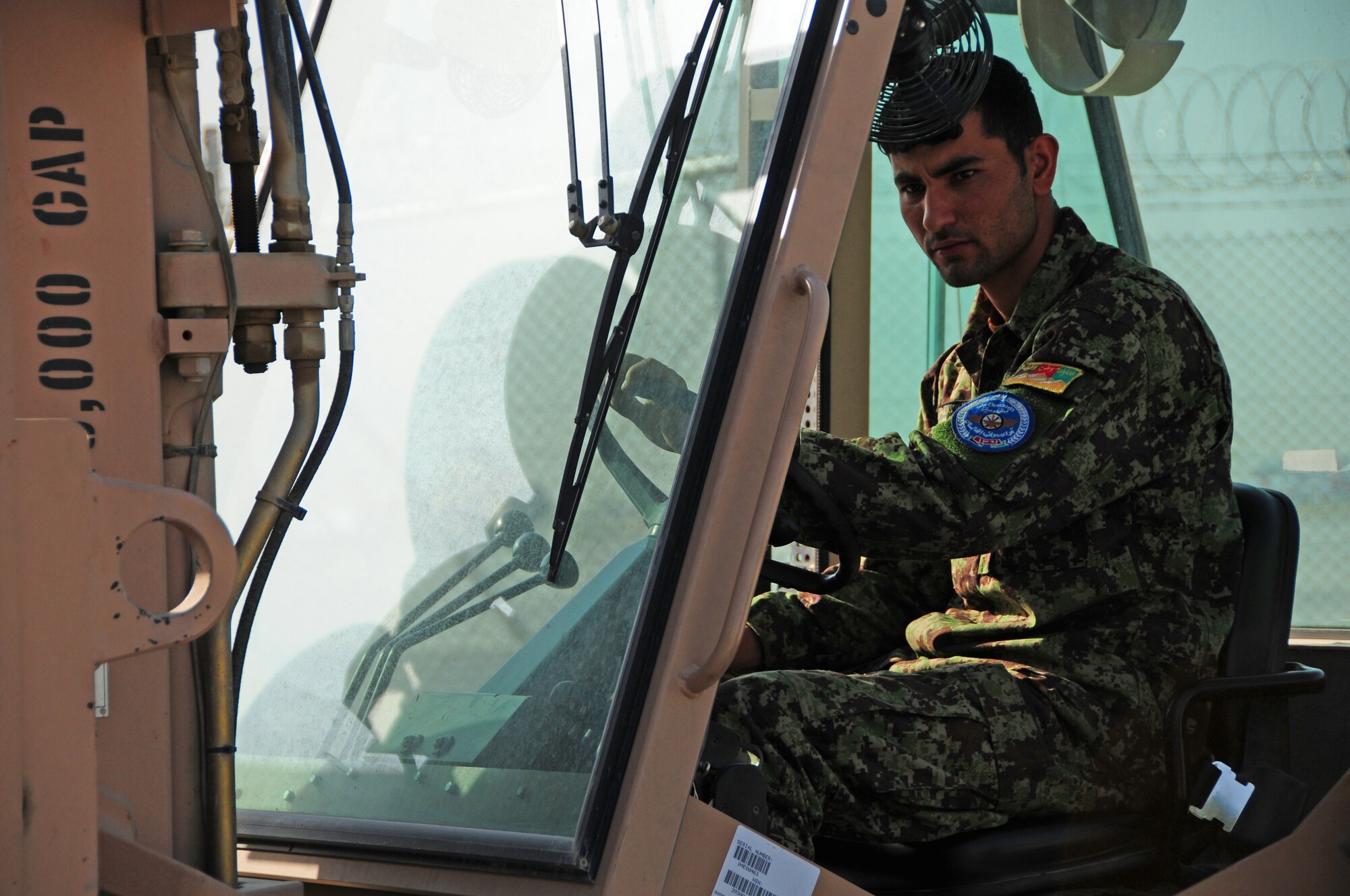 An Afghan Air Force Airman prepares to move cargo with a forklift for a recent shipment of AAF helicopter parts at Kabul International Airport, Kabul, Afghanistan, June 6, 2011. Deployed Airmen here at the 438th Air Expeditionary Wing, are responsible for setting the conditions for a professional, fully independent and operationally-capable Afghan Air Force. (U.S. Air Force photo by Senior Airman Amber Williams)