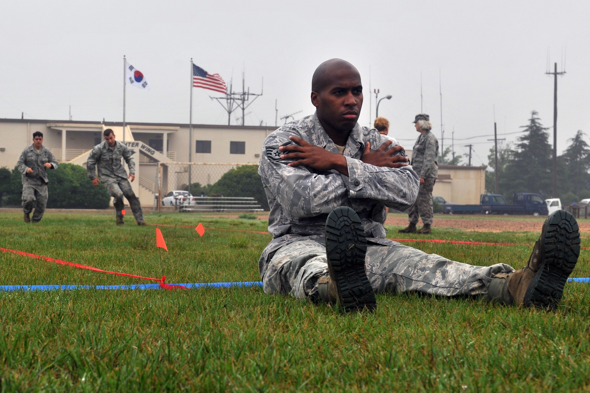 KUNSAN AIR BASE, Republic of Korea -- Airmen compete in the maneuver under fire portion of the Marine Corps Combat Fitness test here July 1. The maneuver under fire consists of a 300 yard shuttle run that includes a variety of combat-related tasks, to include: crawls, buddy drags and carries, ammunition resupply, grenade throw and agility running. (U.S. Air Force photo/Senior Airman Brittany Y. Bateman)