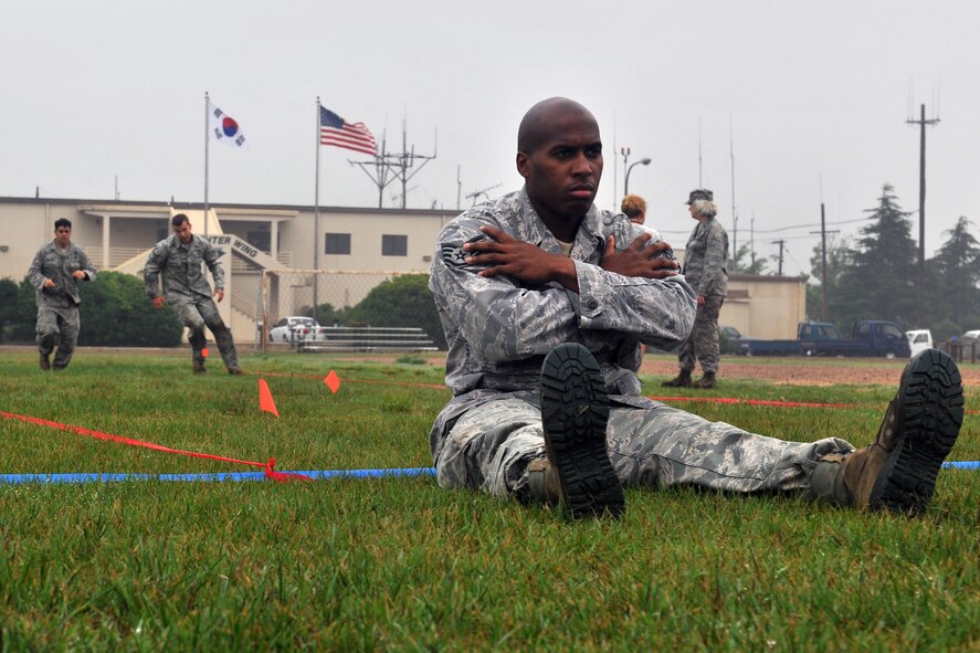 KUNSAN AIR BASE, Republic of Korea -- Airmen compete in the maneuver under fire portion of the Marine Corps Combat Fitness test here July 1. The maneuver under fire consists of a 300 yard shuttle run that includes a variety of combat-related tasks, to include: crawls, buddy drags and carries, ammunition resupply, grenade throw and agility running. (U.S. Air Force photo/Senior Airman Brittany Y. Bateman)