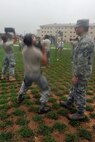 KUNSAN AIR BASE, Republic of Korea -- Airmen compete in the 30 pound ammunition lift during the Marine Corps Combat Fitness Test here July 1. The test consisted of movement to contact; 880 yard run, 30 pound ammunition lift and the maneuver under fire, which was a 300 yard shuttle run that includes a variety of combat-related tasks, to include: crawls, buddy drags and carries, ammunition resupply, grenade throw and agility running. (U.S. Air Force photo/Senior Airman Brittany Y. Bateman)
