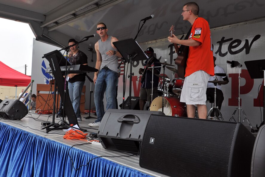 KUNSAN AIR BASE, Republic of Korea -- The Holy Wolves, a base chapel band, performs during the “Fourth on the First” Independence Day celebration here July 1. Events included a bowling tournament, a cardboard boat regatta, a hotdog eating contest, amazing race and a tae kwon do demonstration. (U.S. Air Force photo/Senior Airman Brittany Y. Bateman)