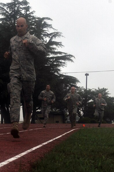 KUNSAN AIR BASE, Republic of Korea -- Airmen run the 880 yard course while participating in the Marine Corps Combat Fitness Test here July 1. The test consisted of movement to contact; 880 yard run, 30 pound ammunition lift and the maneuver under fire, which was a 300 yard shuttle run that includes a variety of combat-related tasks, to include: crawls, buddy drags and carries, ammunition resupply, grenade throw and agility running. (U.S. Air Force photo/Senior Airman Brittany Y. Bateman) 