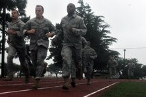 KUNSAN AIR BASE, Republic of Korea -- Airmen run the 880 yard course while participating in the Marine Corps Combat Fitness Test here July 1. The test consisted of movement to contact; 880 yard run, 30 pound ammunition lift and the maneuver under fire, which was a 300 yard shuttle run that includes a variety of combat-related tasks, to include: crawls, buddy drags and carries, ammunition resupply, grenade throw and agility running. (U.S. Air Force photo/Senior Airman Brittany Y. Bateman) 