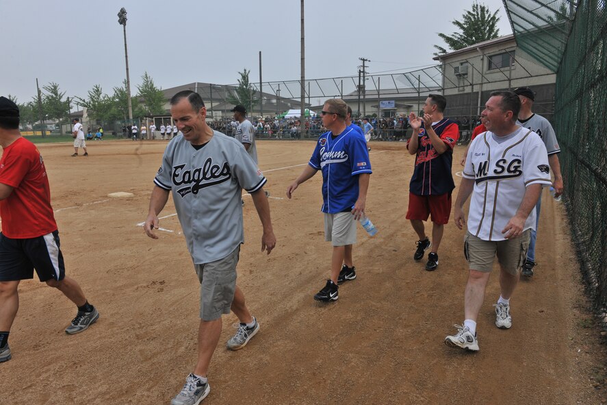 KUNSAN AIR BASE, Republic of Korea -- Defeated, the Eagles return to their dugout after losing to the Chiefs 22-12. The softball game was part of the wing’s Fourth of July celebration. (U.S. Air Force photo/Master Sgt. Sonny Cohrs)