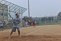 KUNSAN AIR BASE, Republic of Korea -- Col. Scott Pleus, 8th Fighter Wing commander, takes a softball to the arm after walking into a pitch during the Chiefs vs. Eagles softball game here July 1. Unfortunately for the colonel, getting struck by a softball does not get you walked. The Chiefs beat the Eagles 22-12. (U.S. Air Force photo/Master Sgt. Sonny Cohrs)