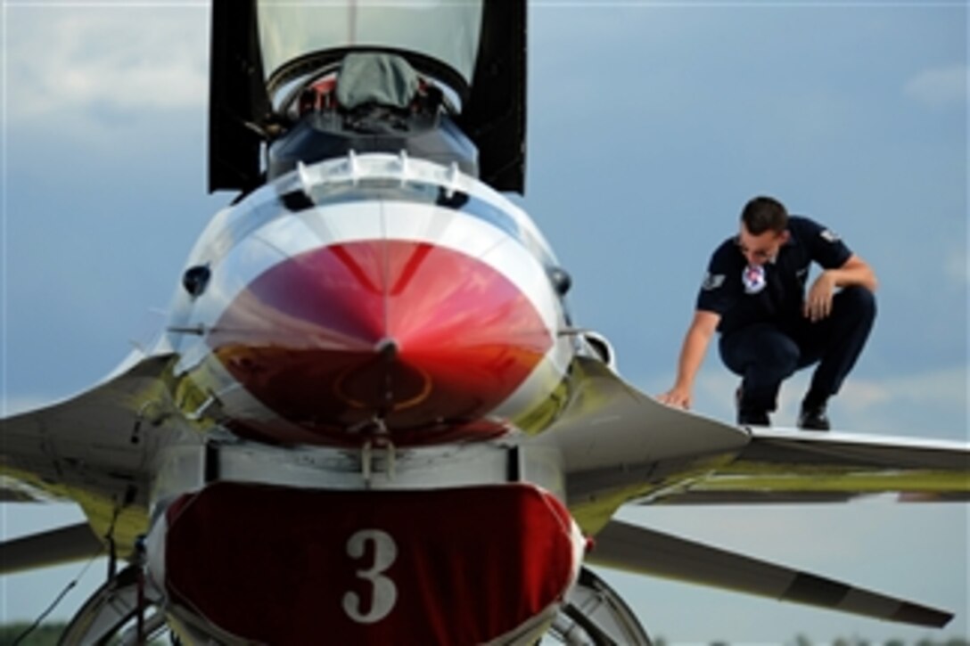 U.S. Air Force Staff Sgt. Stephen Leonardi, a crew chief with the Air Force's air demonstration team, the Thunderbirds, checks for loose screws on the wing of an F-16 Fighting Falcon aircraft during post-flight maintenance at Royal Air Force Waddington, England, on June 30, 2011.  The Thunderbirds are on a six-week European tour during which they are scheduled to perform in nine countries.  