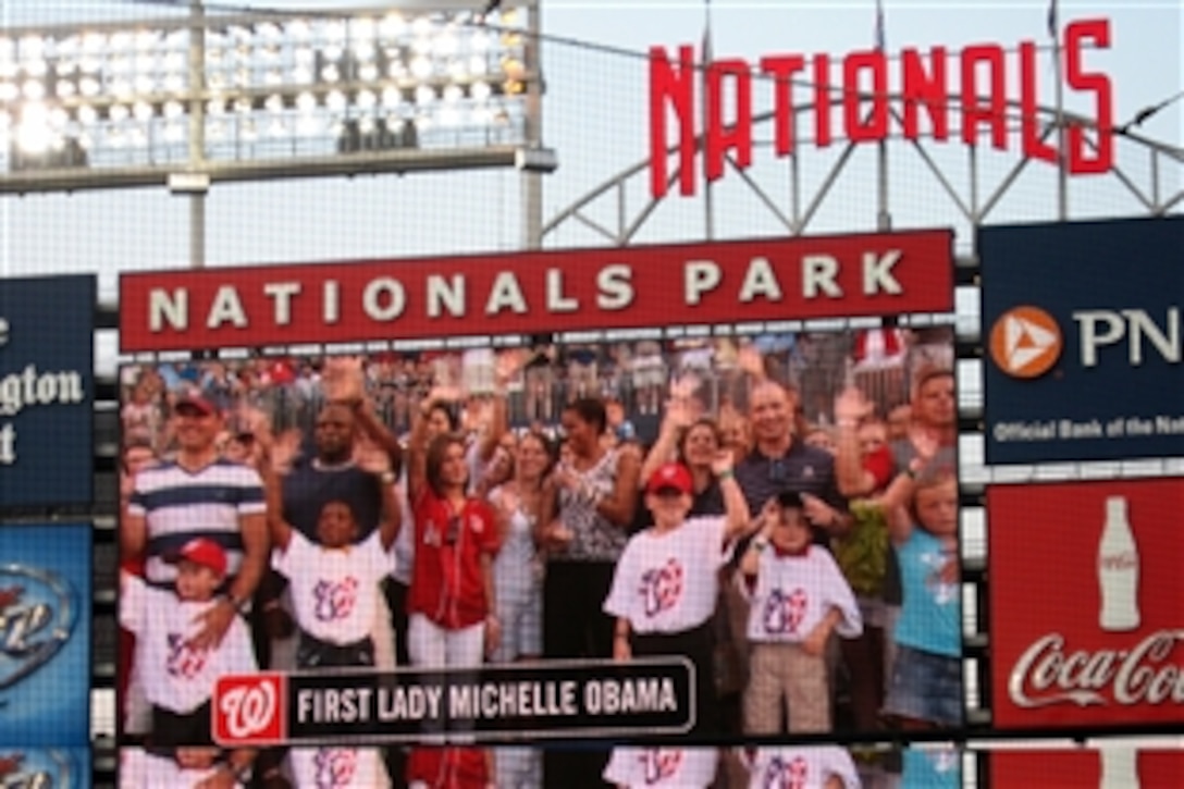 First Lady Michelle Obama, wife of President Barack Obama, and a group of military children are displayed on a marquee at the Washington Nationals' Park, during their "Joining Forces with the Washington Nationals - Honoring Our Military Families," event honoring military families, July 5, 2011. Joining Forces is a national initiative spearheaded by the first lady and Dr. Jill Biden, wife of Vice President Joe Biden, to keep support for military families at the forefront of the minds of Americans