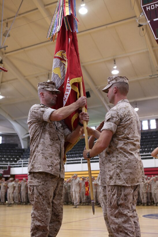 Lieutenant Col. Jeffrey C. Smitherman (right) transfers command of 1st Battalion, 10th Marine Regiment, 2nd Marine Division, to Lt. Col. Robert J. Hallett during a change of command ceremony aboard Marine Corps Base Camp Lejeune July 7, 2011. Smitherman is relinquishing his command after successfully leading 1/10 on their recent deployment to Afghanistan.