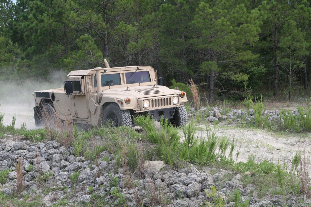 Marines with Truck Company, Headquarters Battalion, 2nd Marine Division, drive a humvee through a rugged practice course to help prepare for future deployments July 7, 2011, aboard Marine Corps Base, Camp Lejeune.
