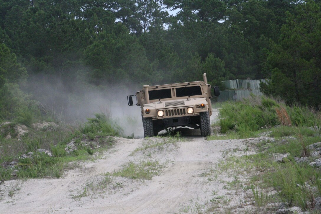 Marines with Truck Company, Headquarters Battalion, 2nd Marine Division, drive a humvee through a rugged practice course to help prepare for future deployments July 7, 2011, aboard Marine Corps Base, Camp Lejeune.