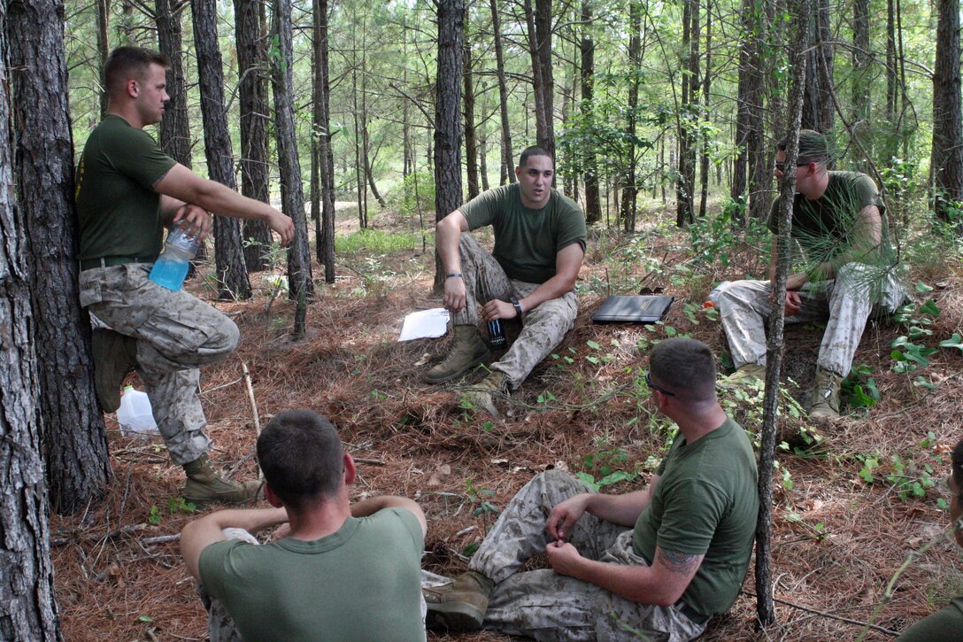 Marines with Truck Company, Headquarters Battalion, 2nd Marine Division, conduct a period of military education before practicing their driving skills in rugged terrain aboard Marine Corps Base, Camp Lejeune, July 7, 2011.