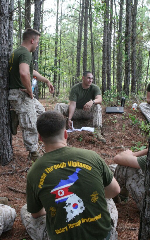 Marines with Truck Company, Headquarters Battalion, 2nd Marine Division, conduct a period of military education before practicing their driving skills in rugged terrain aboard Marine Corps Base, Camp Lejeune, July 7, 2011.