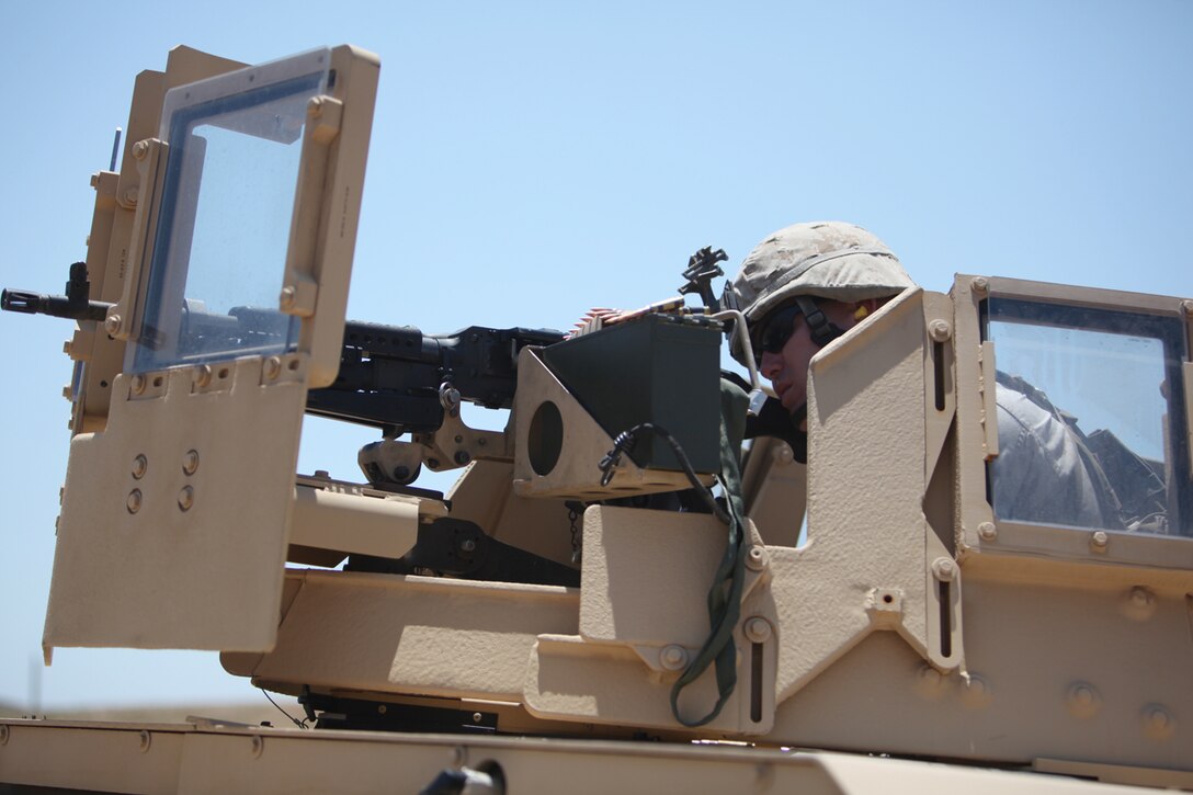 Staff Sgt. Matthew Harrington with the Police Advisory Team assigned to 1st Light Armored Reconnaissance Battalion sights in during a heavy machine gun range here, July 7. Harrington is one of many PAT members training for a deployment to Afghanistan with 1st LAR. PAT members will train Afghan security forces in an effort to help stabilize the country.
