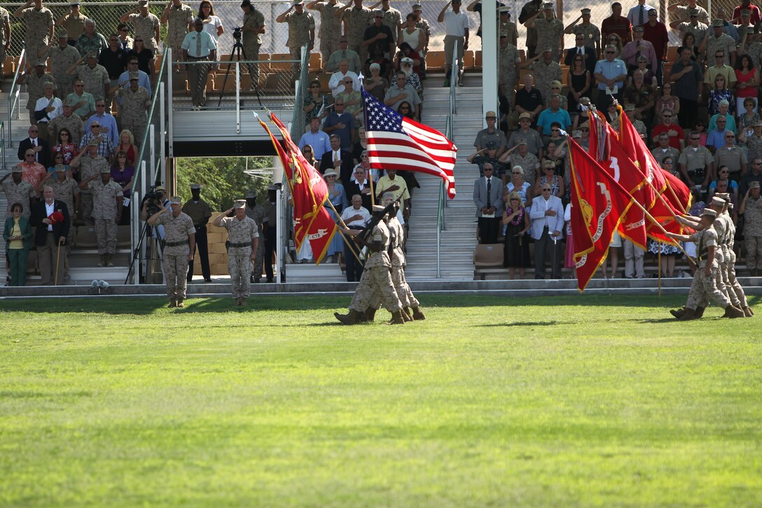 Brigadier Gen. George W. Smith Jr., the oncoming commanding general [left], and Brig. Gen. H. Stacy Clardy III, the outgoing commanding general, salute the colors during their change of command ceremony at Lance Cpl. Torrey L. Gray Field July 7, 2011.::r::::n::