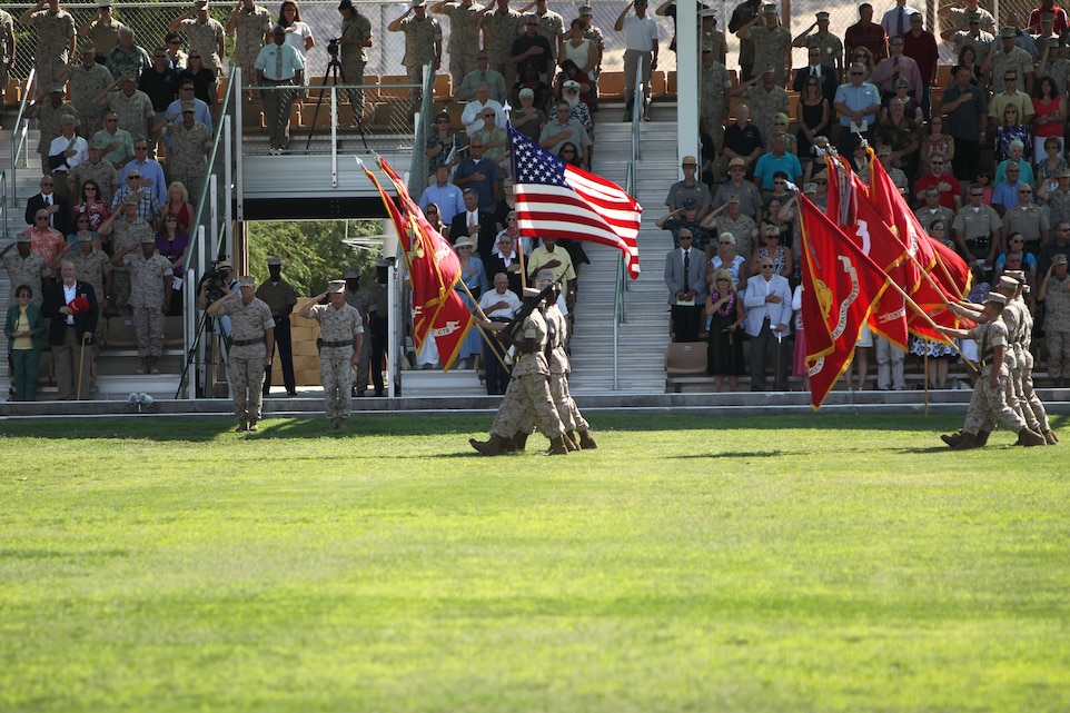 Brigadier Gen. George W. Smith Jr., the oncoming commanding general [left], and Brig. Gen. H. Stacy Clardy III, the outgoing commanding general, salute the colors during their change of command ceremony at Lance Cpl. Torrey L. Gray Field July 7, 2011.::r::::n::