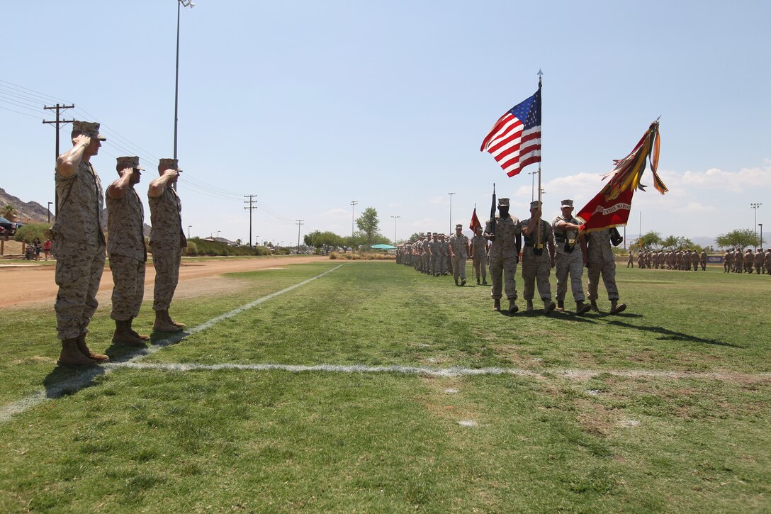 Lieutenant Col. Seth Folsom, the battalion commanding officer for 3rd Battalion, 7th Marine Regiment; Sgt. Maj. Rafael Rodriguez, the oncoming sergeant major for 3/7; and Sgt. Maj. Troy Black, the outgoing sergeant major for 3/7, salute the colors during the pass and review of a post and relief ceremony at Felix Field July 7, 2011.