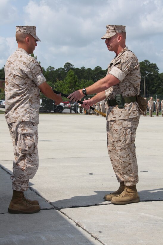 Sgt. Maj. Brett C. Scheuer passes the unit enlisted sword to Lt. Col. Paul A. Rosenbloom during the Marine Wing Support Squadron 271 Relief and Appointment Ceremony at the squadron headquarters July 7.