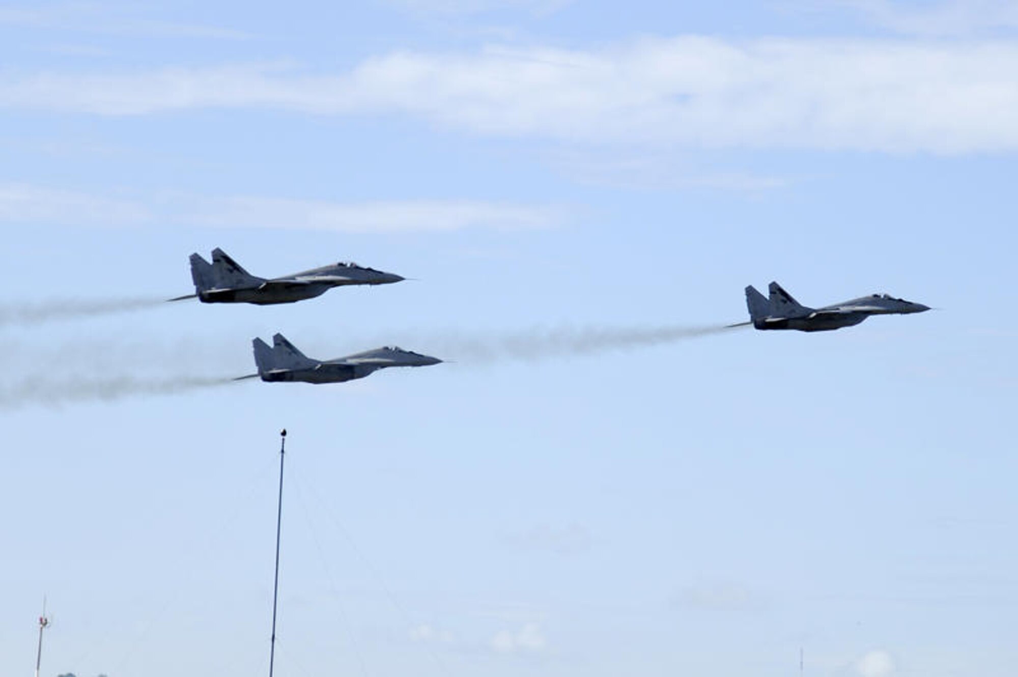 Brunei Darussalam -- Three MiG-29's from the Royal Malaysian Air Force fly over Rimba Air Base as they practice for an aerial show preformed during the 3rd Biennial Brunei Darussalam International Defense Exhibition in Brunei Darussalam July 3. BRIDEX provides an engaging and effective platform for leading manufacturers, suppliers and decision makers to deliberate on military solutions and showcase innovative technologies. Two F-16 Fighting Falcons and 15 members from the 35th Fighter Wing from Misawa Air Base, Japan, represented the U.S. Air Force and PACAF during the four-day event for the first time. (U.S. Air Force photo/Staff Sgt. Marie Brown/Released)