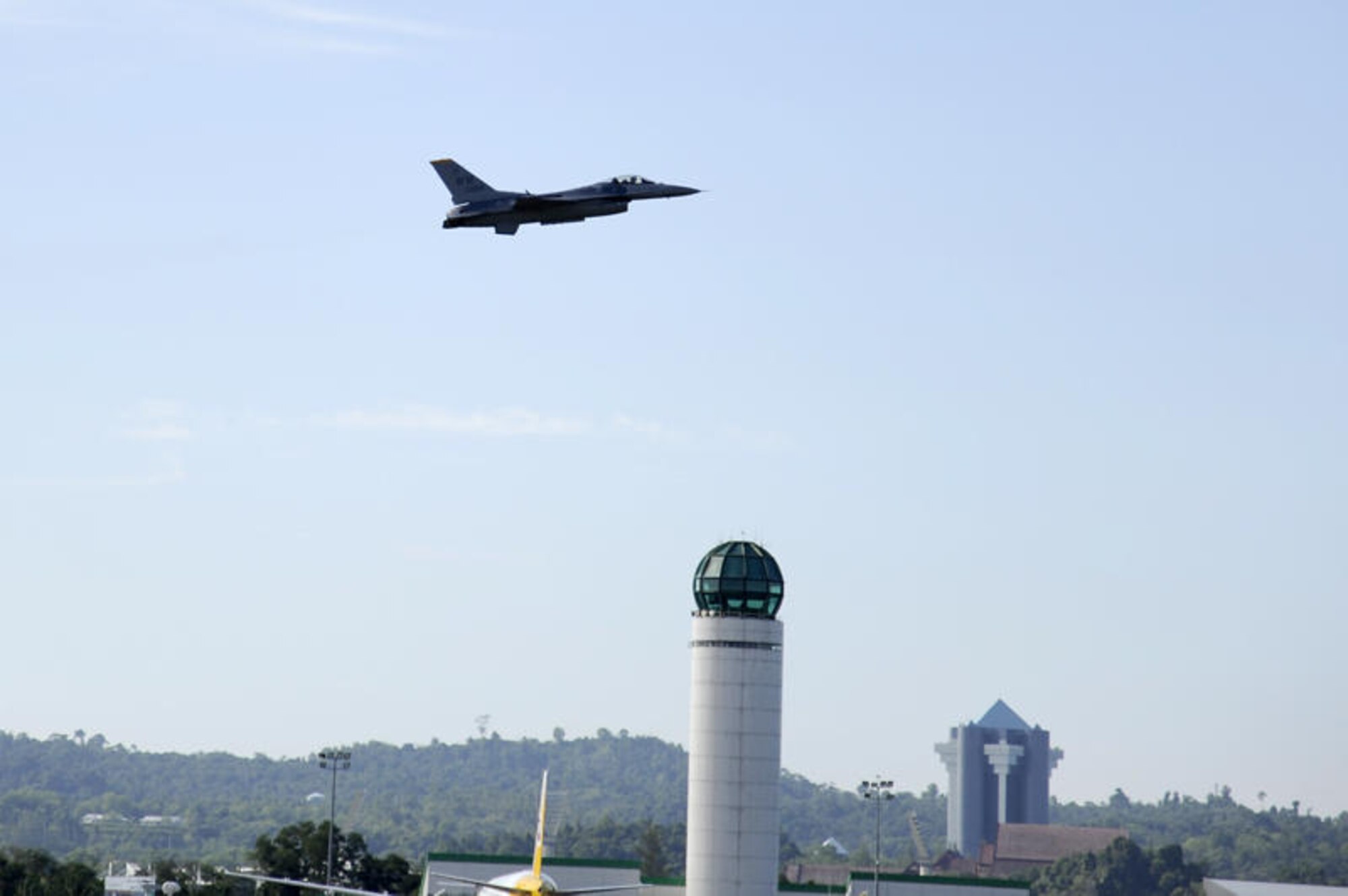 Brunei Darussalam -- Capt. Chris Nations, Pacific Air Forces Demonstration Team pilot, flies over Rimba Air Base after take-off during an aerial show practice for the 3rd Biennial Brunei Darussalam International Defense Exhibition in Brunei Darussalam July 3. This year coincides with the 50th anniversary of the Royal Brunei Armed Forces and is forecasted to host more than 160 exhibitors and 150 international delegates. (U.S. Air Force photo/Staff Sgt. Marie Brown/Released)