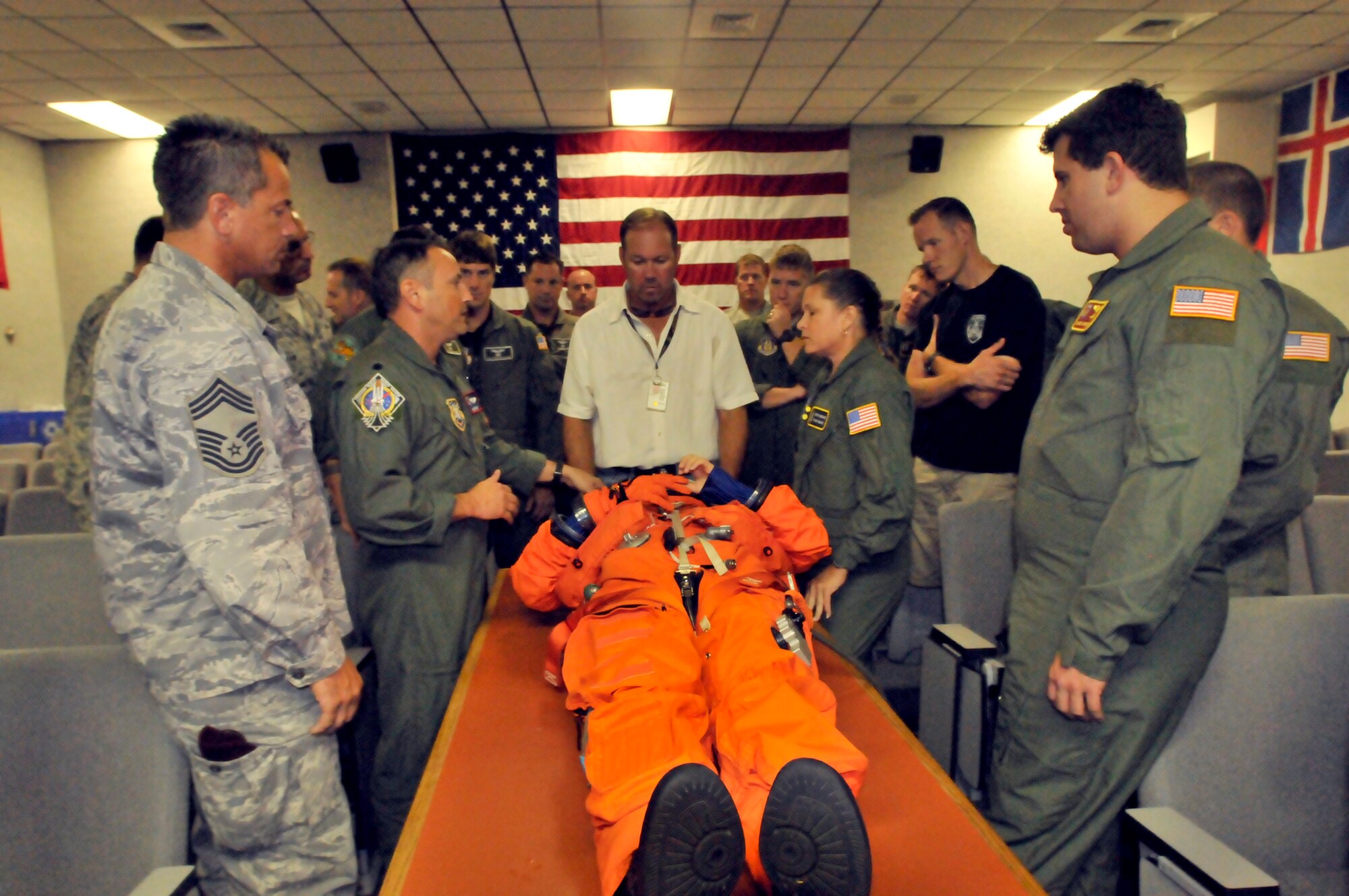 PATRICK AIR FORCE BASE, Fla. - A day prior to the Space Shuttle Atlantis u lanch, Reserve Airmen listen to the details of removing the Advanced Crew Escape Suit (ACES) - a full pressure suit currently worn by all space shuttle crew for the ascent and entry portions of flight. These Guardian Angels also learned how to extract an astronaut in the case of an emergency.  The 920th RQW provides rescue support for all NASA space shuttle. (U.S. Air Force photo/Airman First Class Natasha Dowridge)