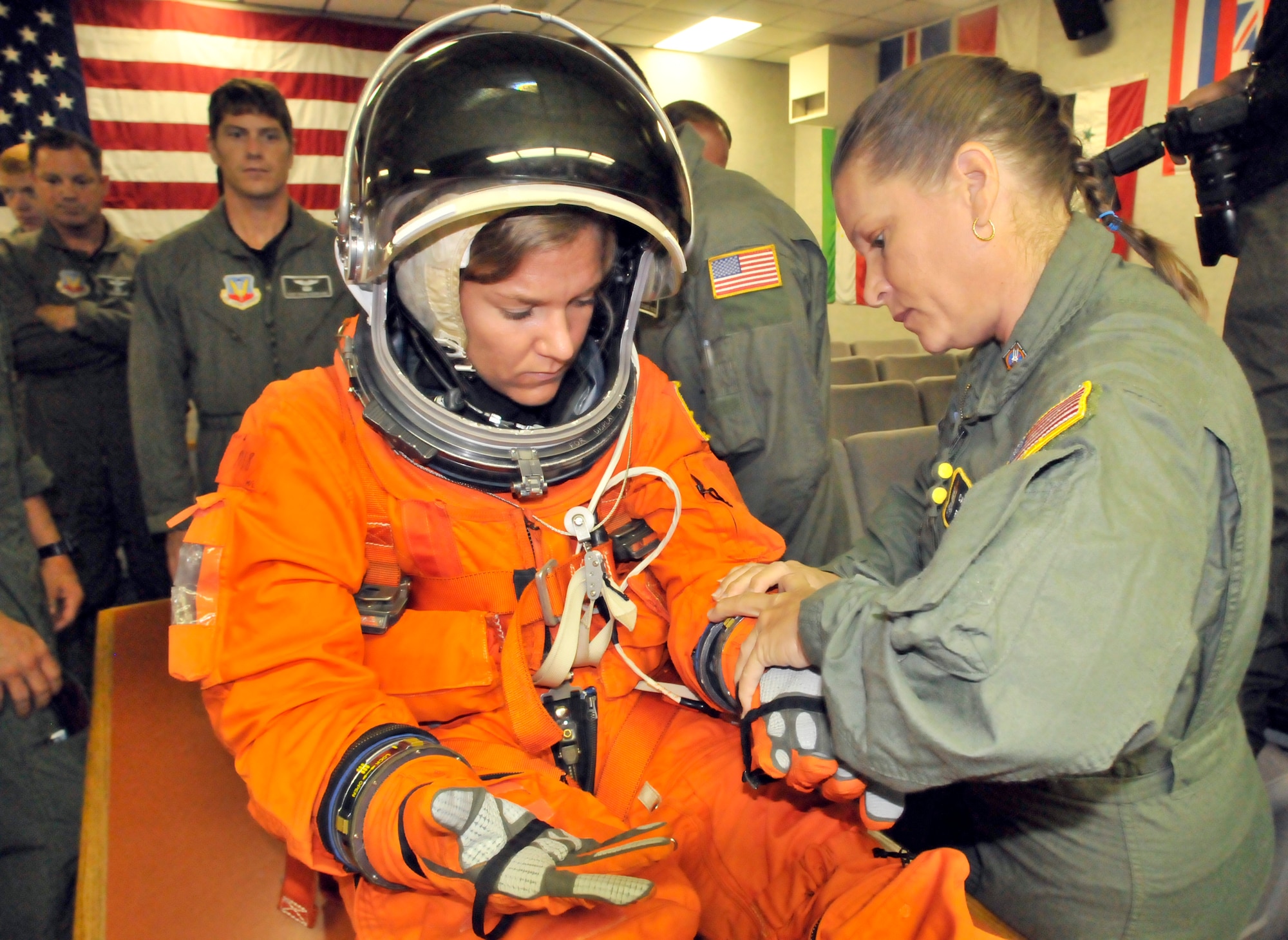 PATRICK AIR FORCE BASE, Fla.- Staff Sgt. Leslie Forshaw, assistant chief of public affairs for the 920th Rescue Wing, and Ms. Cathy Dibiase, flight nurse, help with the pararescuemen briefing here, for the upcoming shuttle launch. Ms. Dibiase is demonstrating to the PJs how to properly remove the gear from an astronaut if something were to happen to the shuttle. The 920th provides rescue support for all NASA space shuttle missions, including safety and security surveillance of the Eastern Range. (U.S. Air Force photo/Airman First Class Natasha Dowridge)