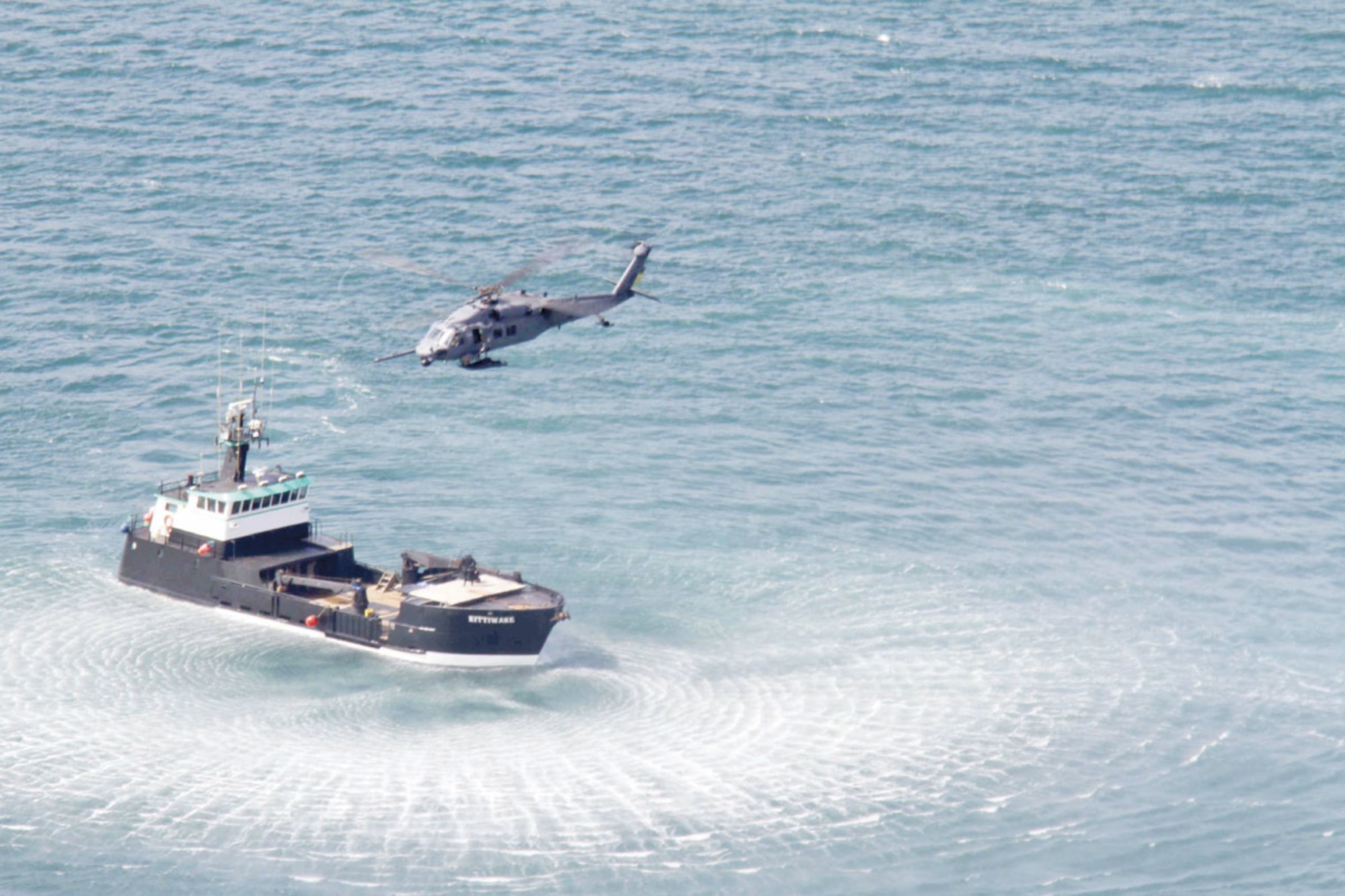 An Alaska Air National Guard HH-60 Pave Hawk helicopter hovers above the F/V Kittywake to hoist a pararescueman and victim during a water training exercise June 30. The training was documented by a camera crew from Discovery Channel’s “Surviving the Cut” for an upcoming season. (U.S. Air Force photo/2nd Lt. Bernie Kale)