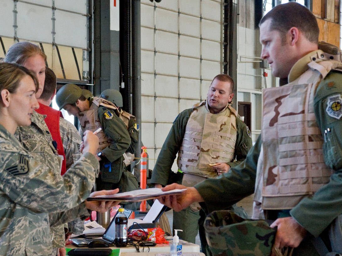 Ellsworth Airmen walk through a simulated processing line during a Phase I Operational Readiness Exercise at Ellsworth Air Force Base, S.D.,  June 22, 2011. During this portion of the ORE, Airmen have the opportunity to visit with representatives from various base agencies to ensure they have properly simulated out-processing. (U.S. Air Force photo/Airman Alystria Maurer/Released)
